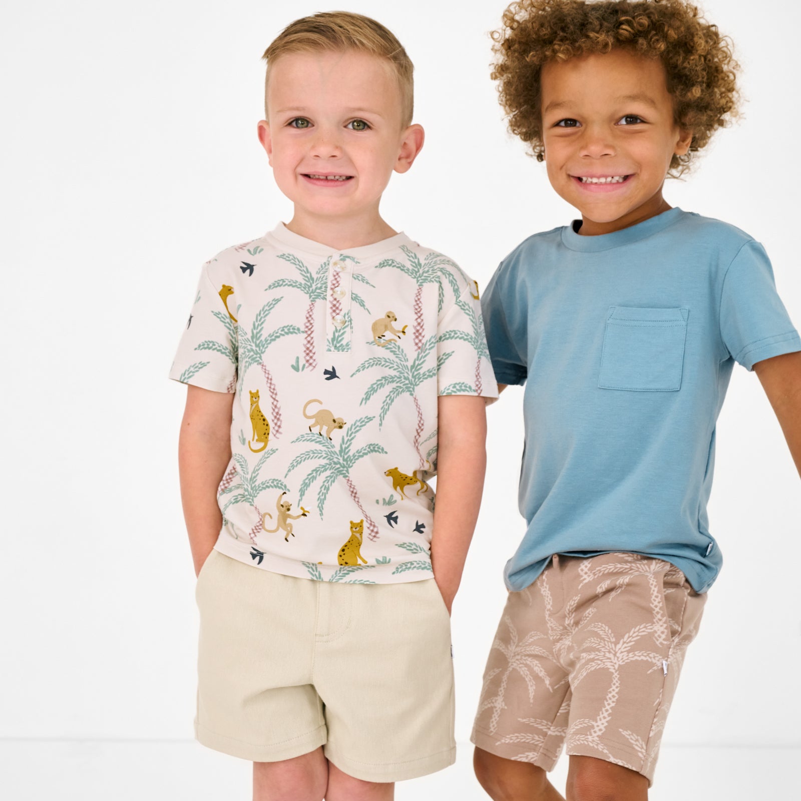 Two children wearing Wild Escape and Sandy Palms play styles