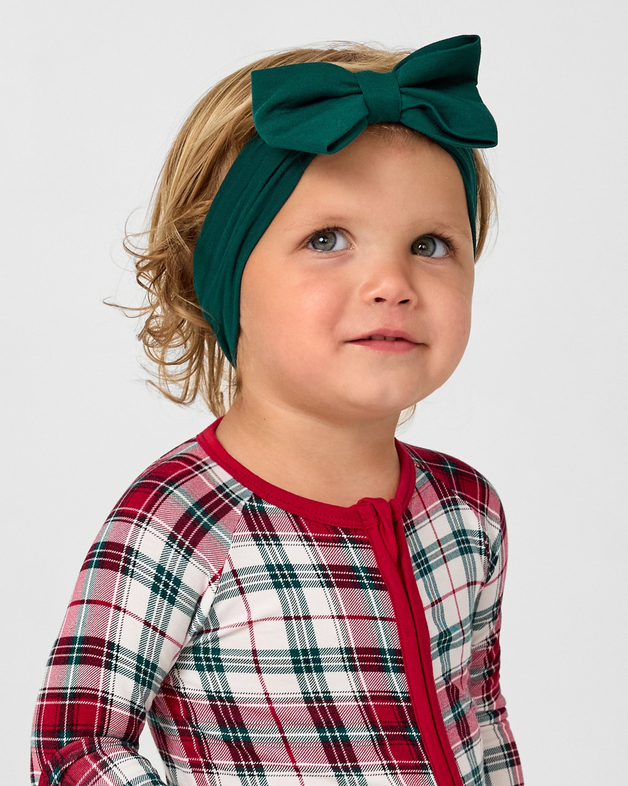 Child wearing the Emerald Luxe Bow Headband