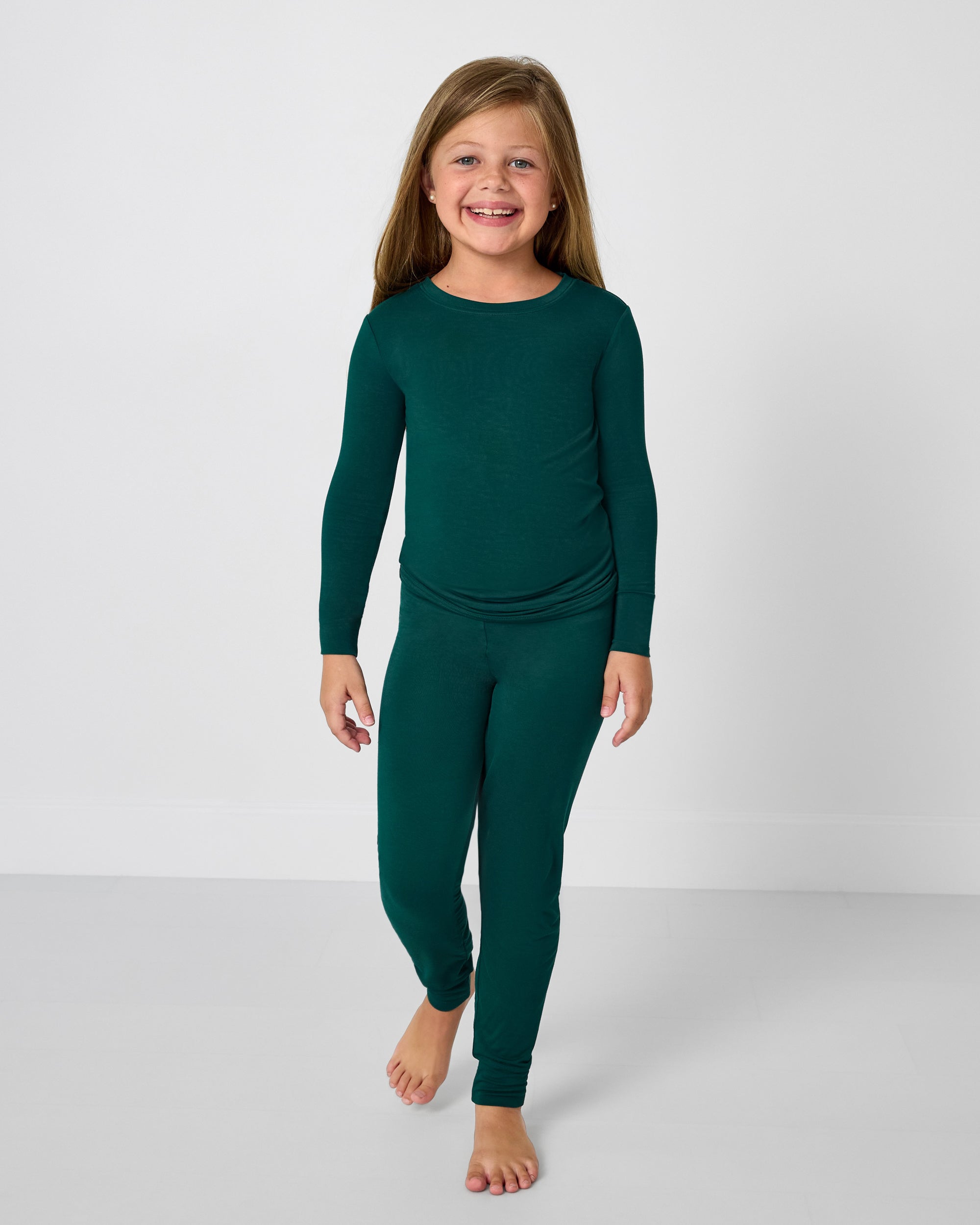 Standing girl wearing the Emerald Two-Piece Pajama Set