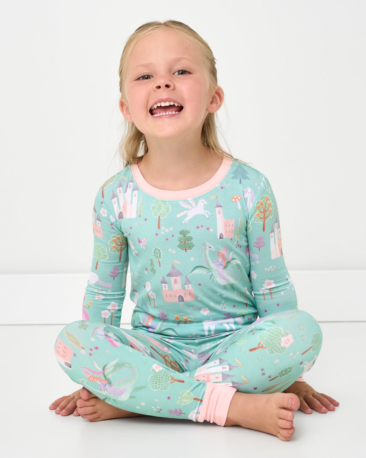 Sitting girl wearing the Enchanted Fairytale Two-Piece Pajama Set