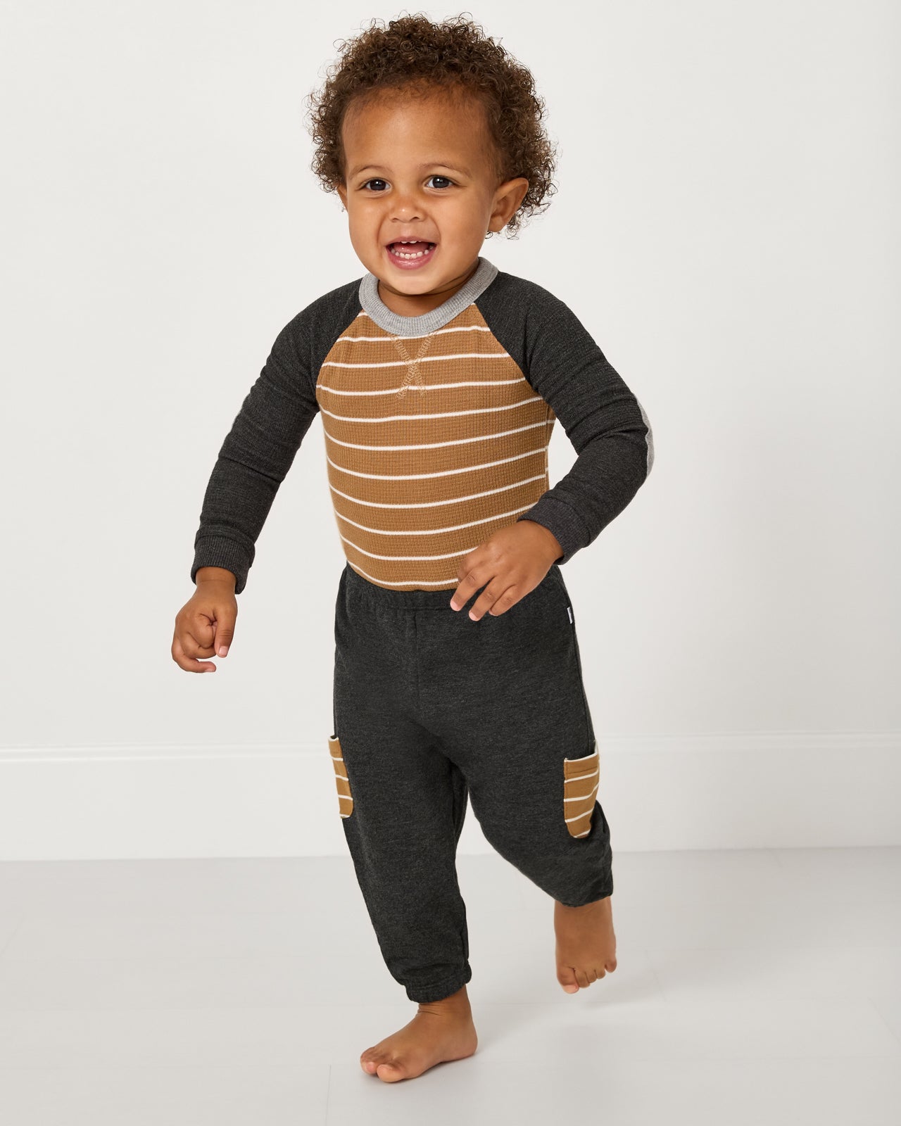 Running child wearing the Heather Black Cinched Jogger with a waffle tee