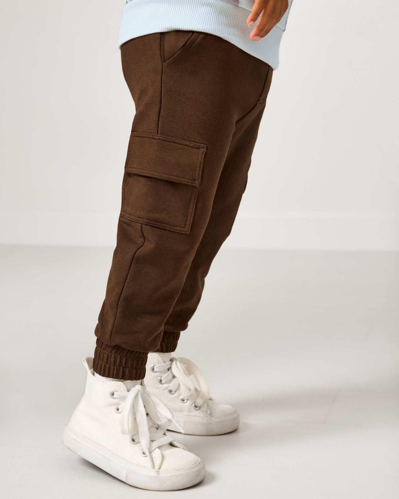 Side view of boy wearing the Mocha Cargo Jogger
