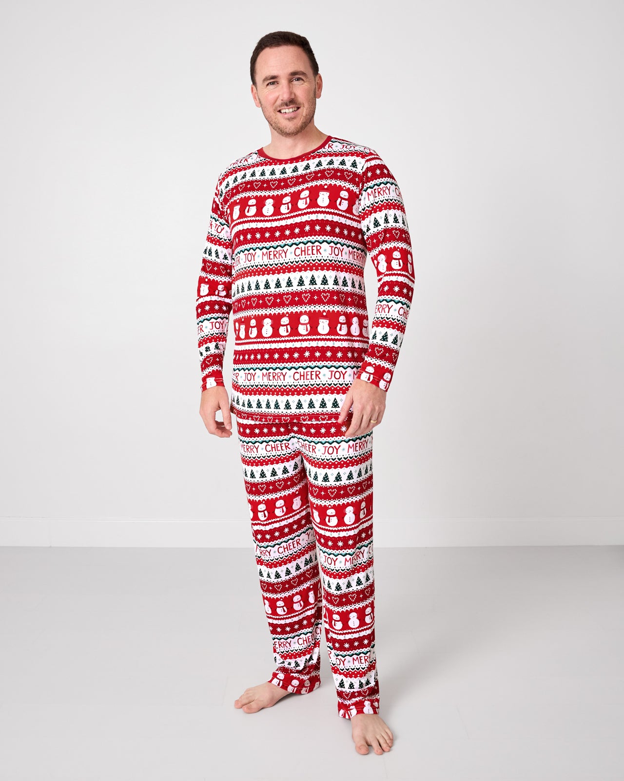 Standing man wearing the Festive Fair Isle Men's Pajama Pants with a matching pj top