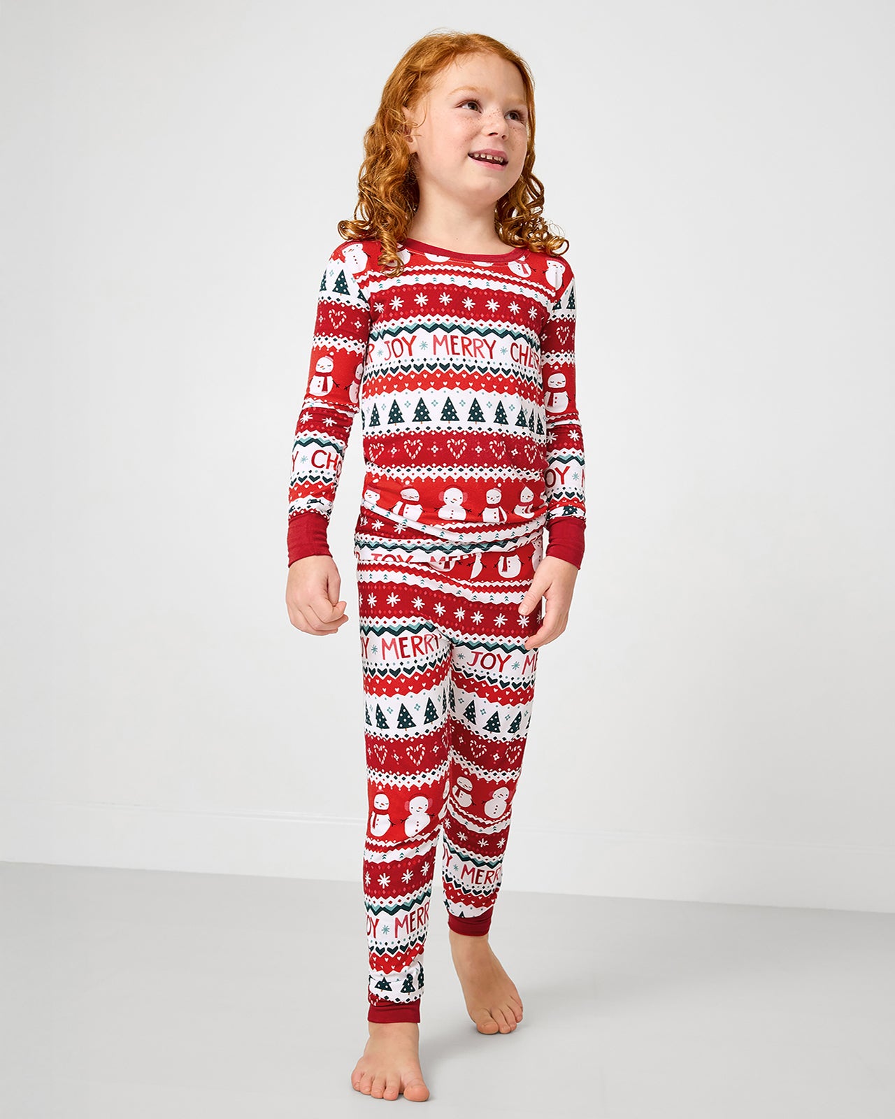 Standing girl wearing the Festive Fair Isle Two-Piece Pajama Set