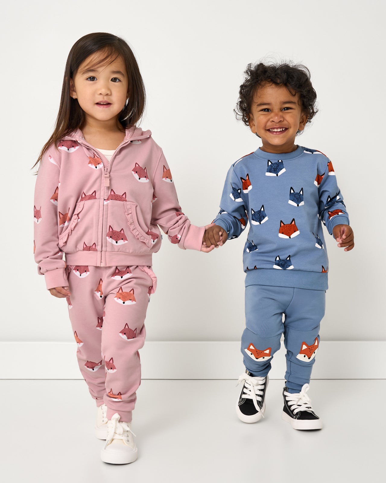 Two children wearing matching Fox Tracks Sweat Sets