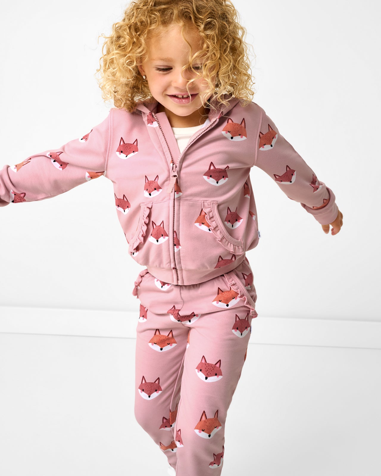 Close up of girl wearing the Fox Tracks Ruffle Jogger and matching ruffle hoodie