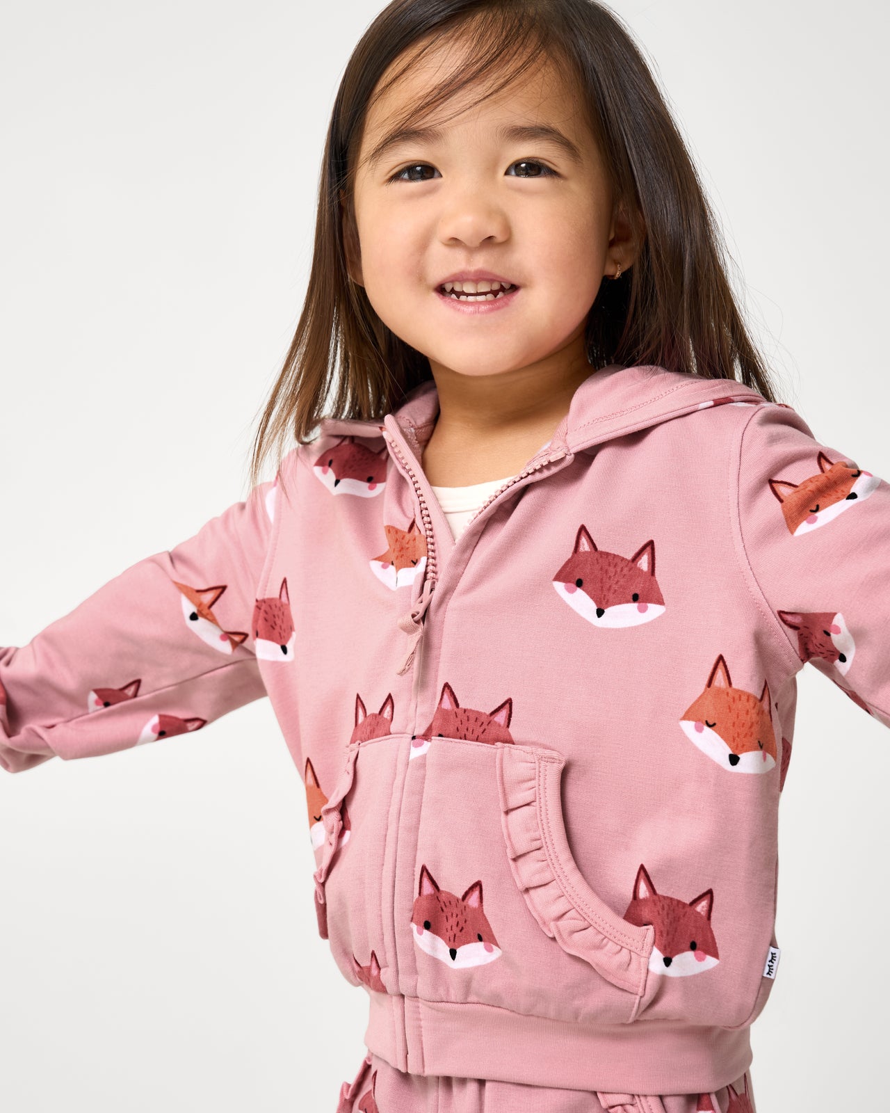 Close up of child wearing the Fox Tracks Ruffle Zip Hoodie