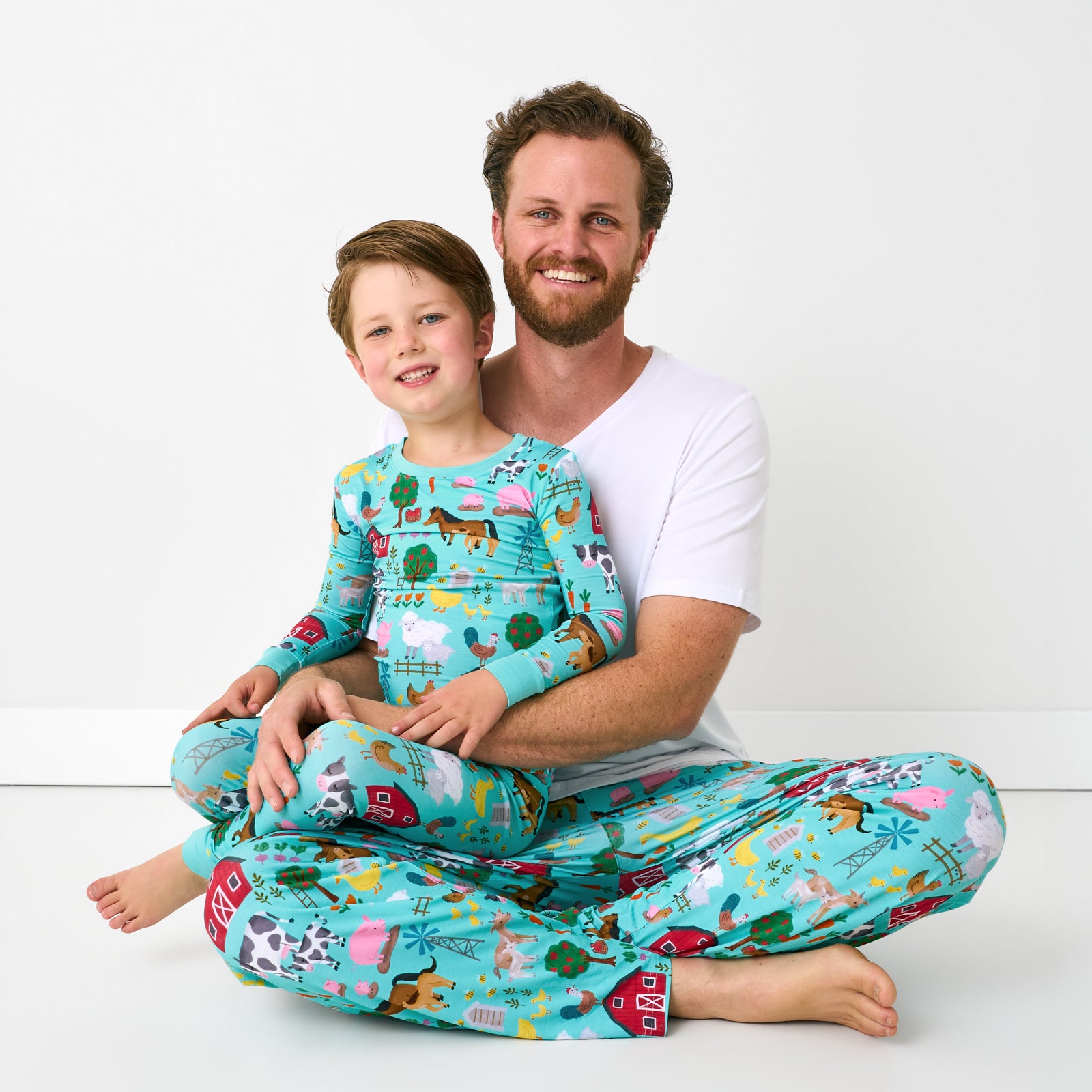 Father and son wearing matching Turquoise Farm Fam bamboo pajamas