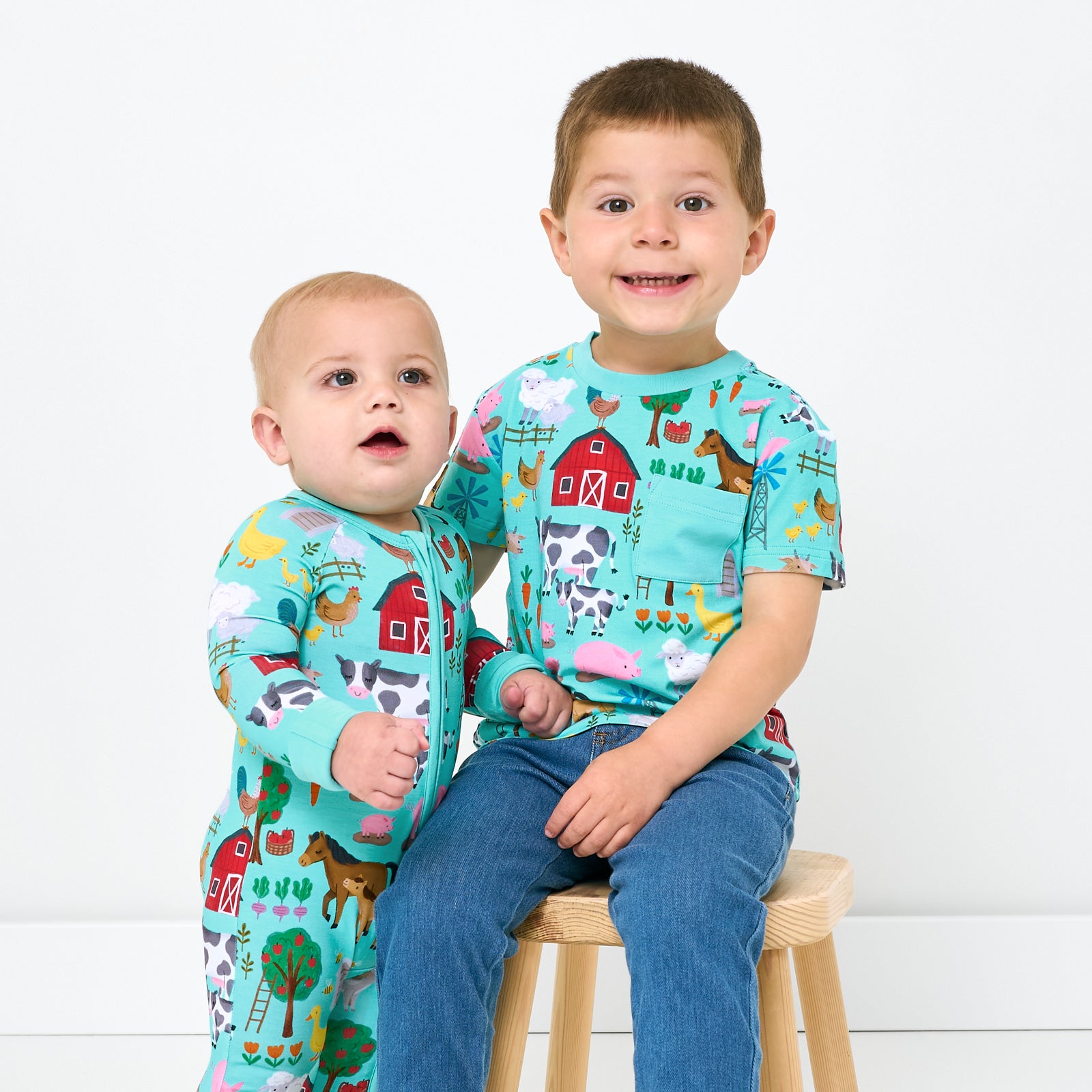 Two children wearing matching Turquoise Farm Fam styles