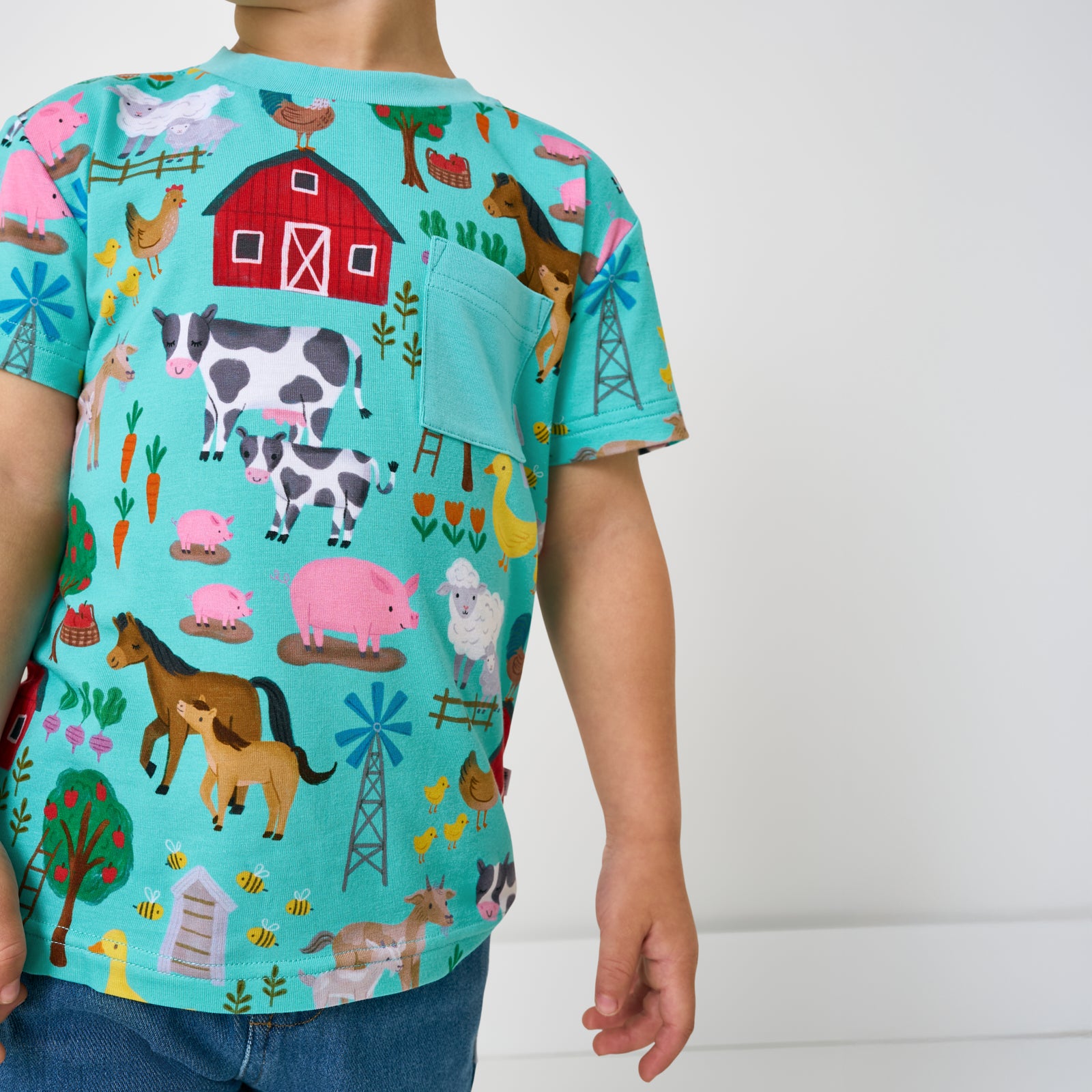 Close up of the pocket detail on the Turquoise Farm Fam Relaxed Pocket Tee