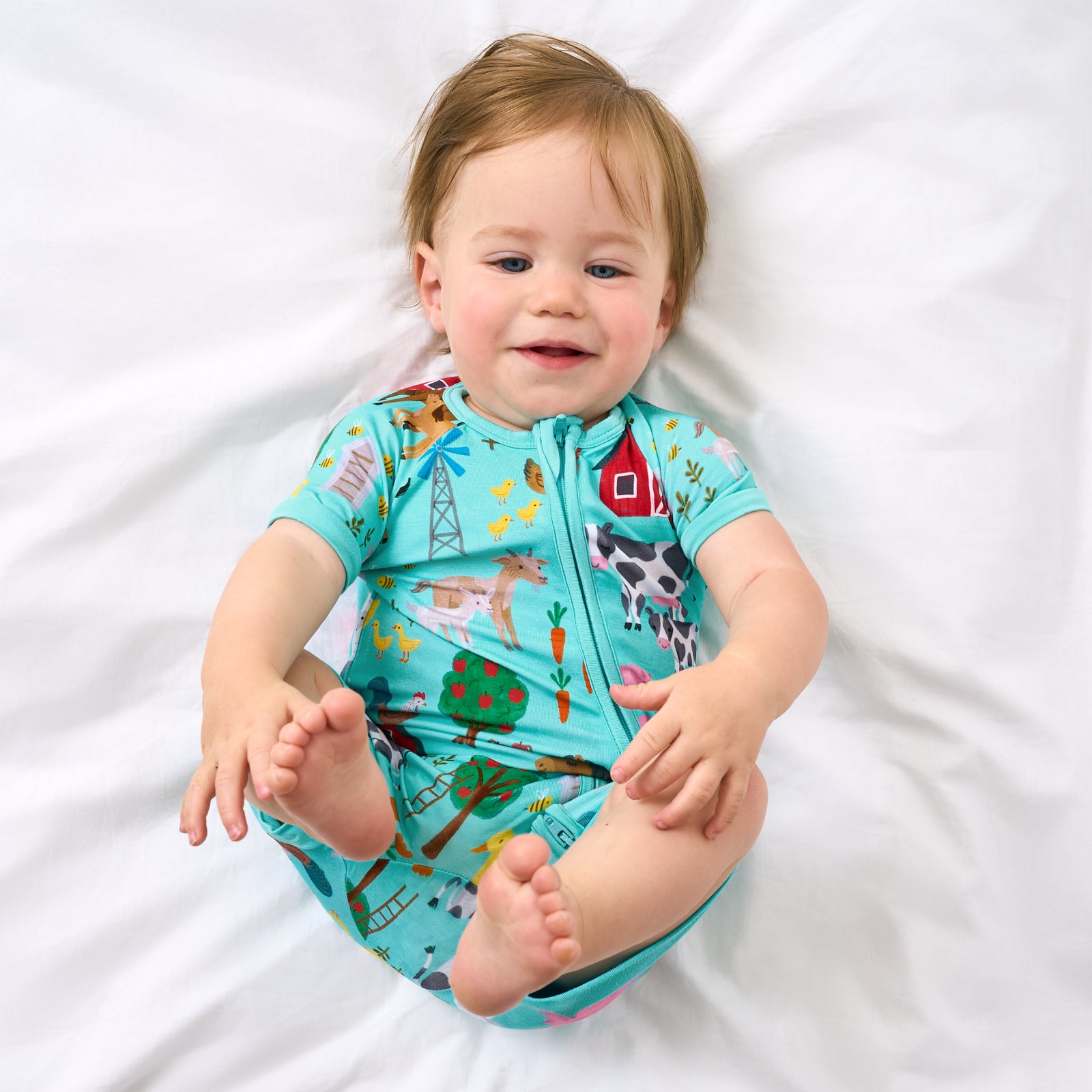 Alternate aerial view of child wearing the Turquoise Farm Fam Shorty Zippy