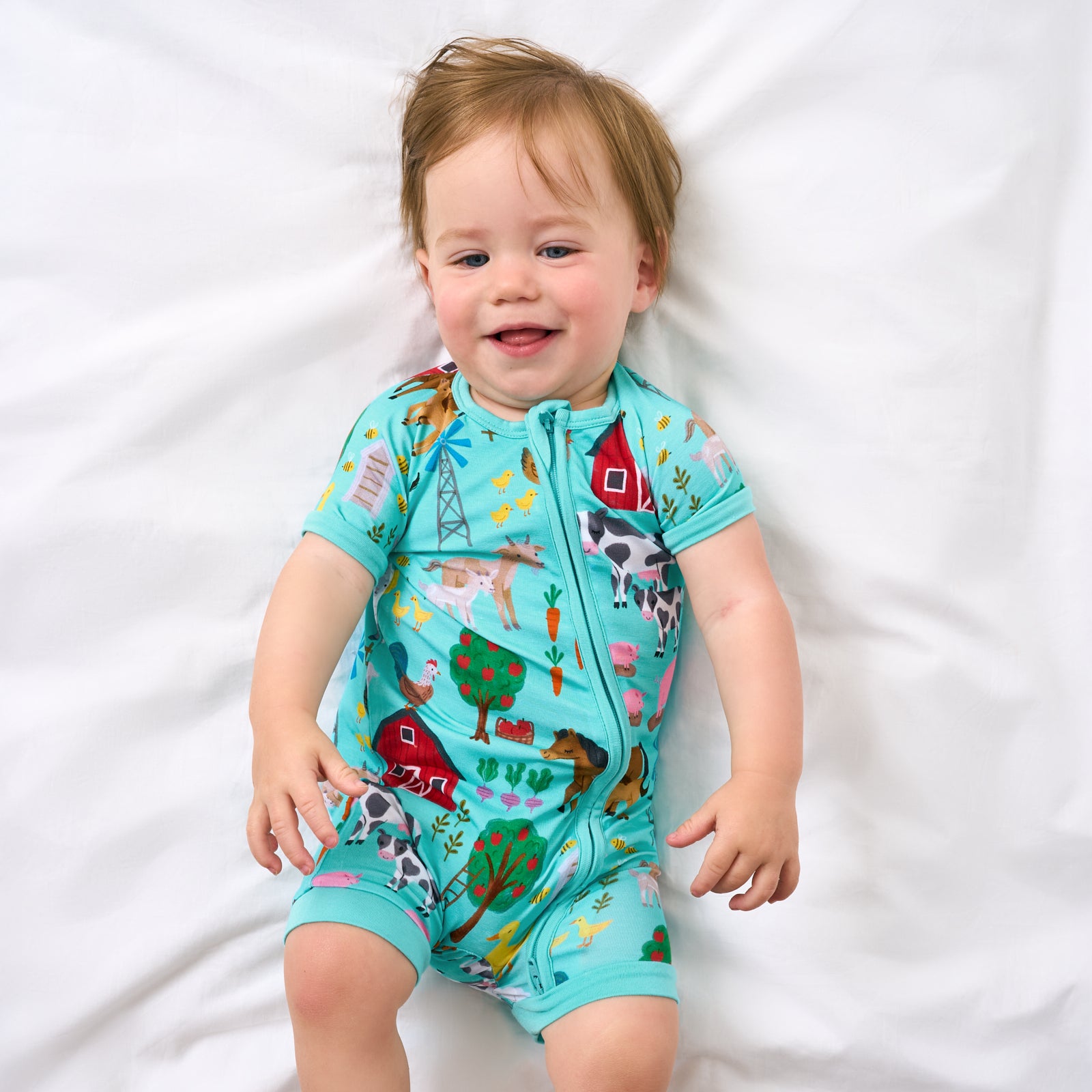 Aerial view of child wearing the Turquoise Farm Fam Shorty Zippy