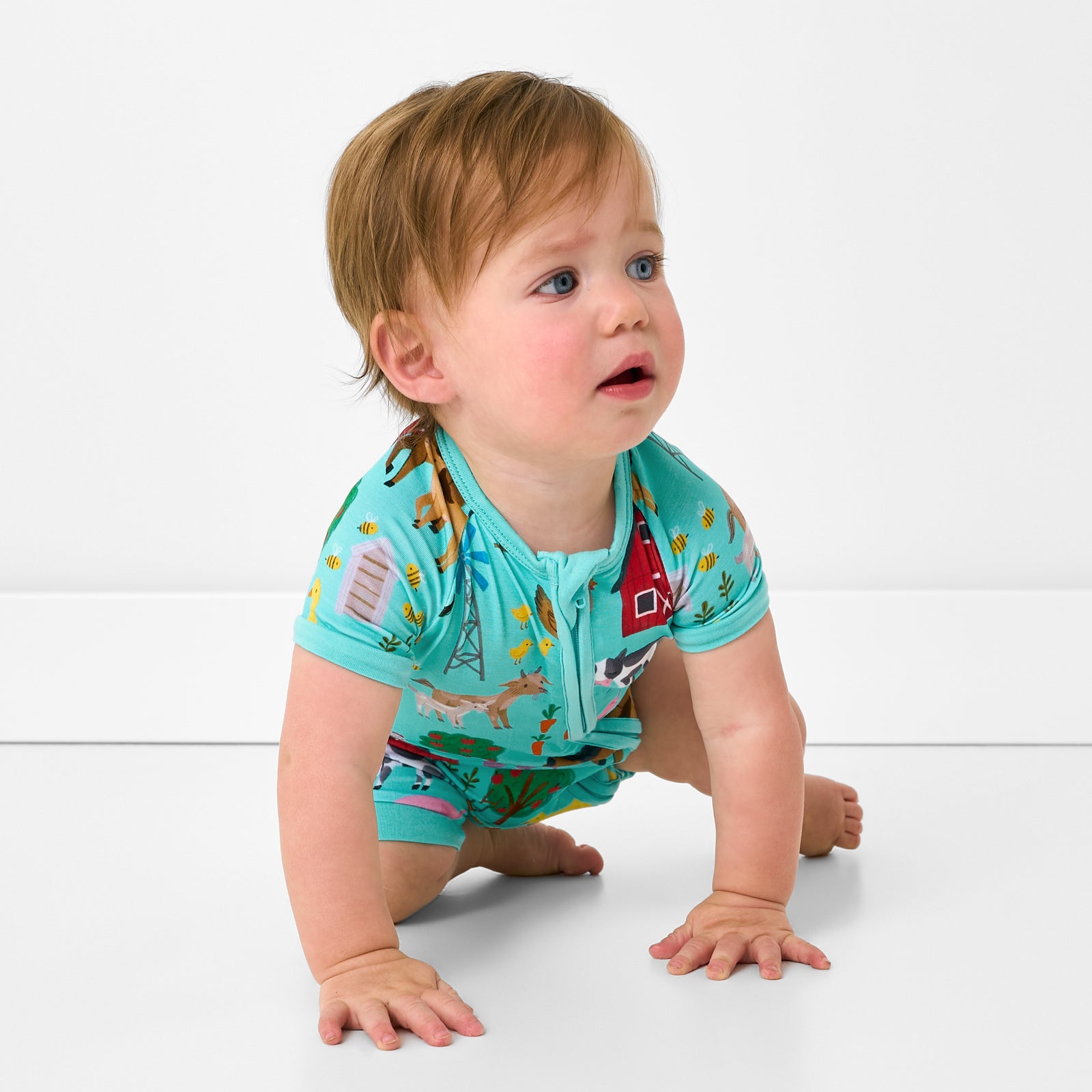 Crawling child wearing the Turquoise Farm Fam Shorty Zippy