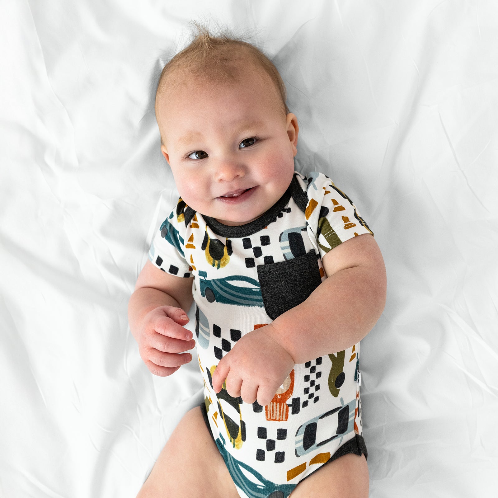 Close up arial view of child wearing the Fast Lane Pocket Bodysuit