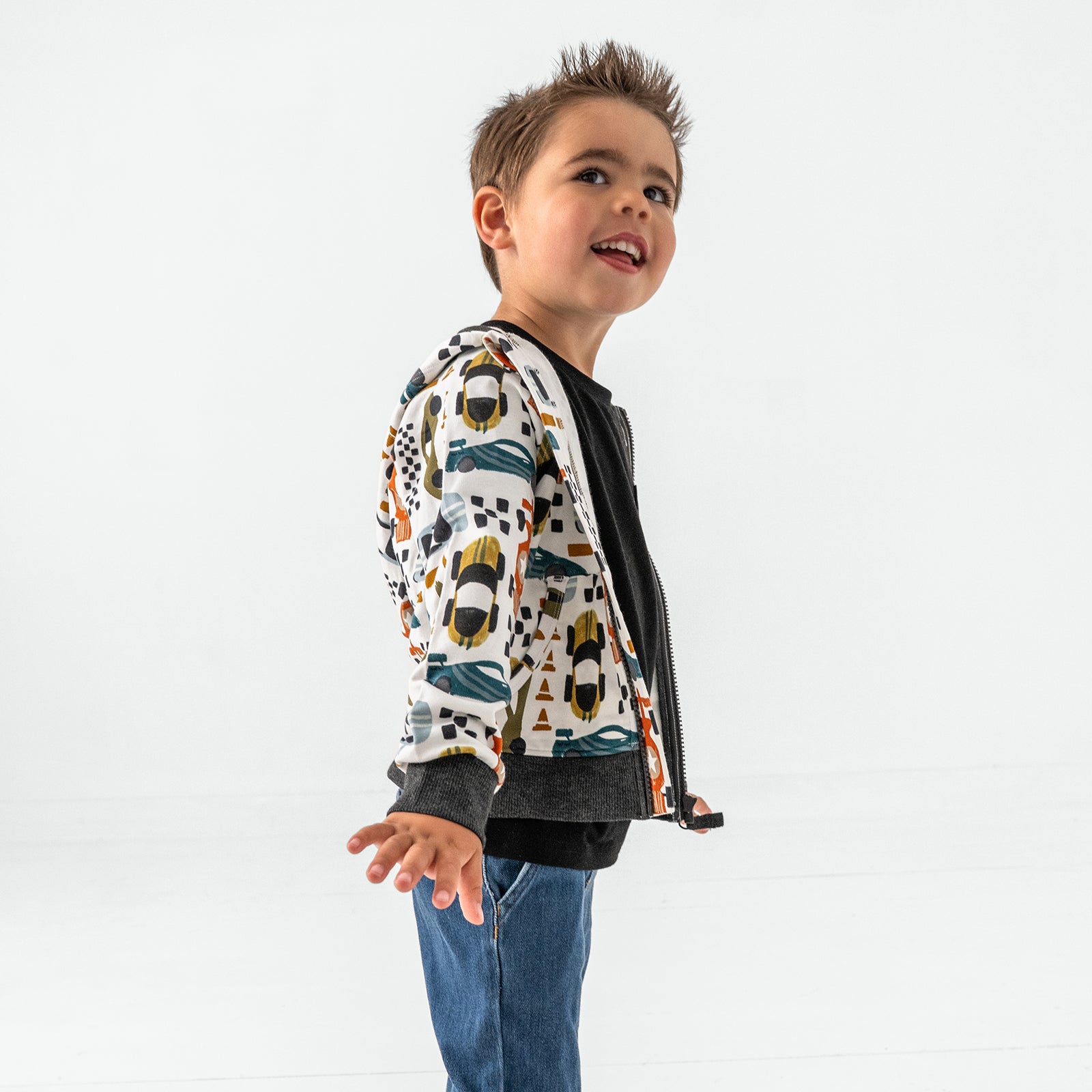 Posing child wearing the Fast Lane Zip Bamboo Hoodie
