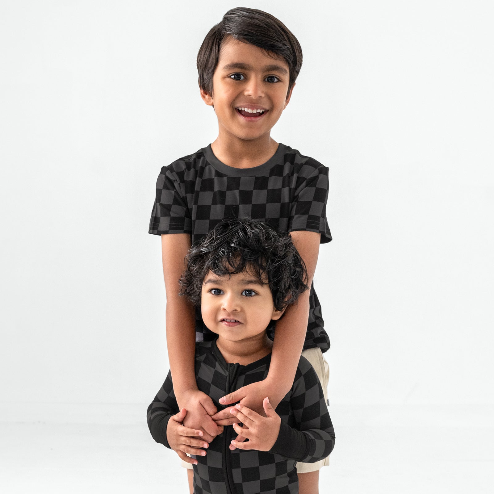 Two children wearing matching Monochrome Checks styles