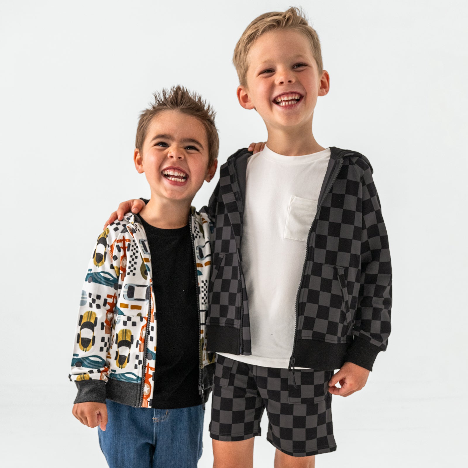 Two children wearing a mix of Fast Lane and Monochrome Checks styles