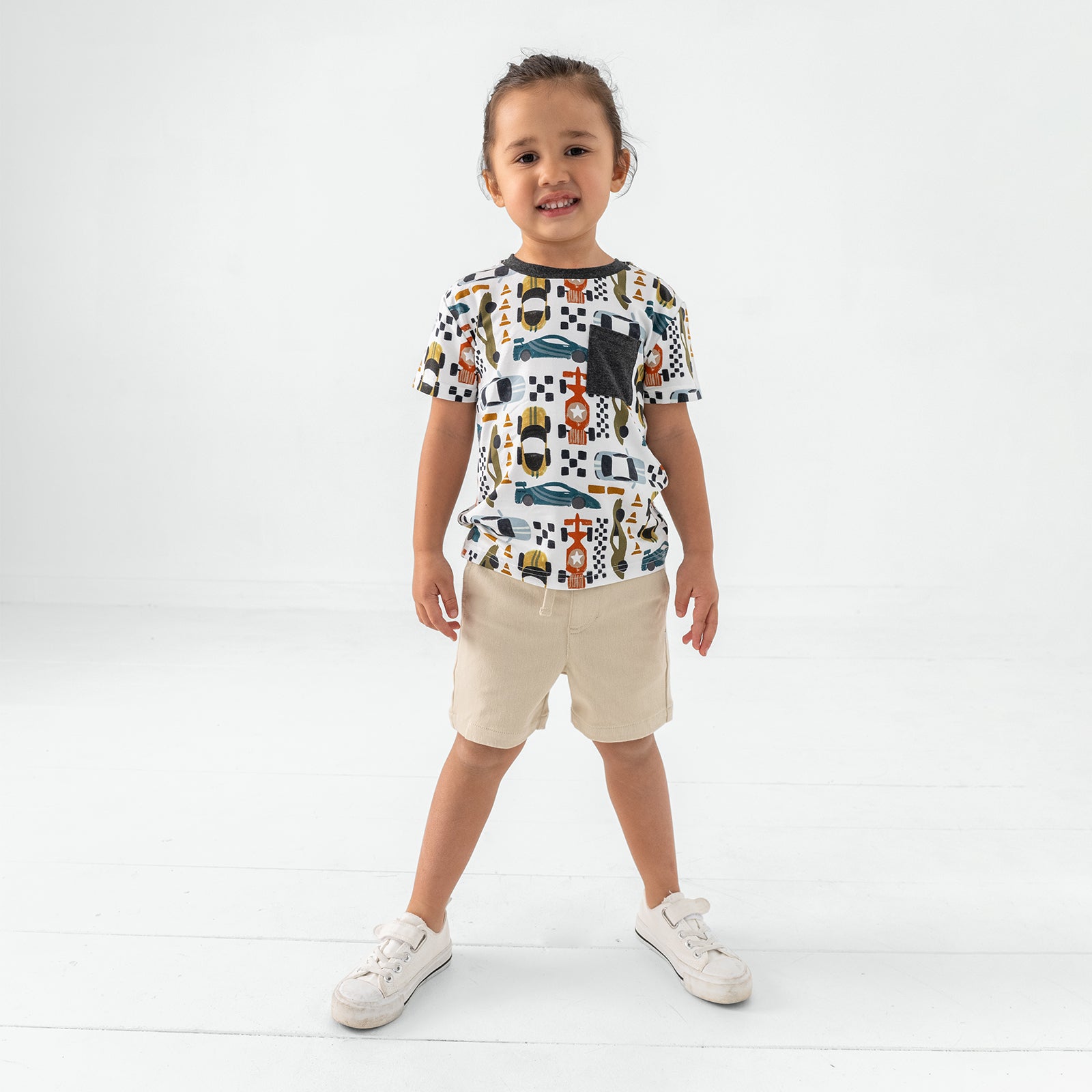 Standing child wearing the Fast Lane Short Sleeve Relaxed Pocket Tee