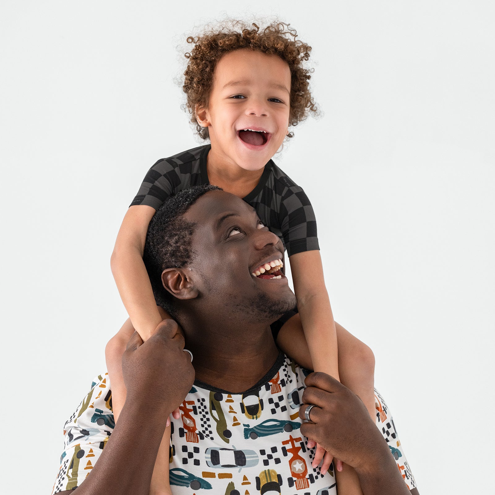Father and son wearing a mix of Fast Lane and Monochrome Checks bamboo pajamas