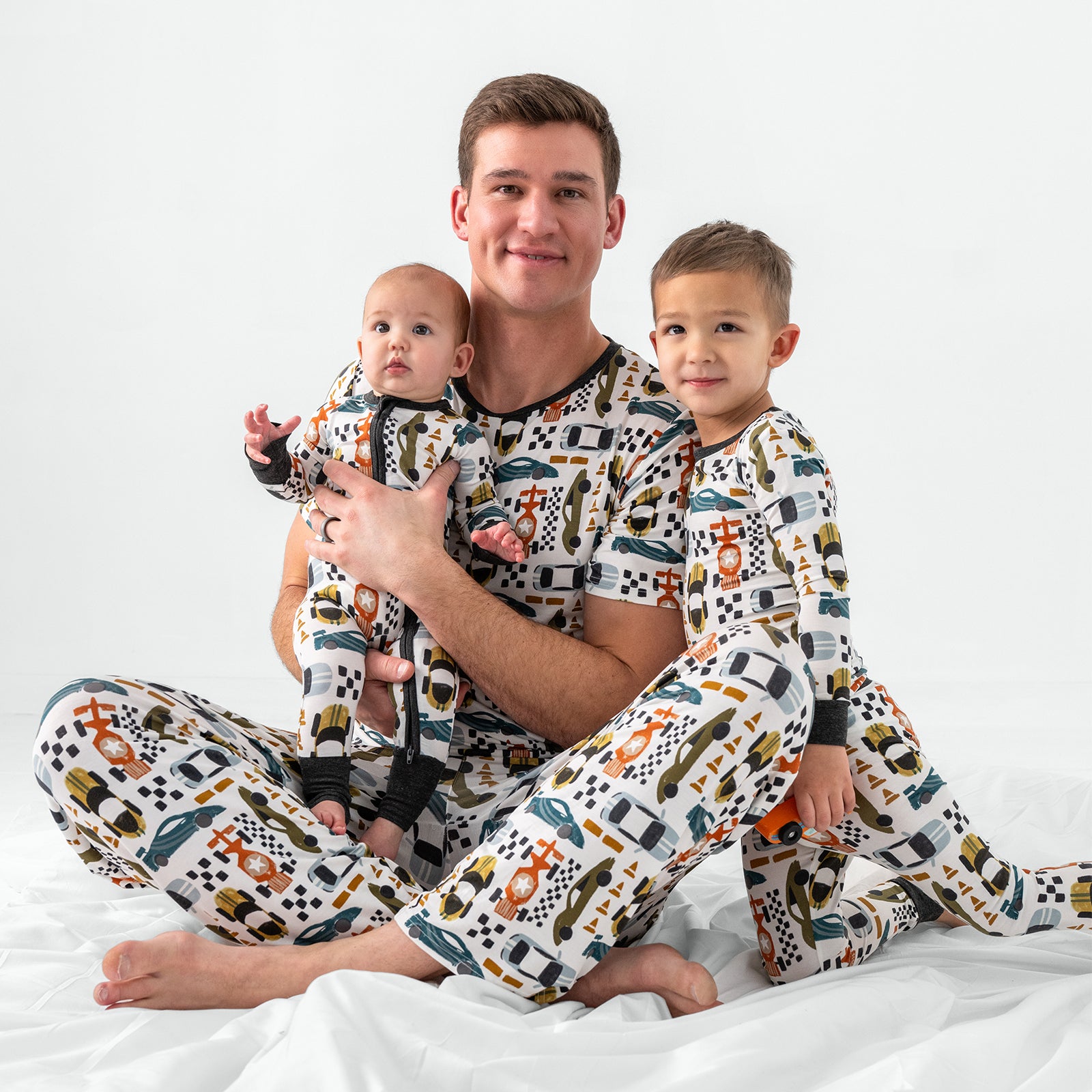 Father and two children wearing matching Fast Lane pajamas