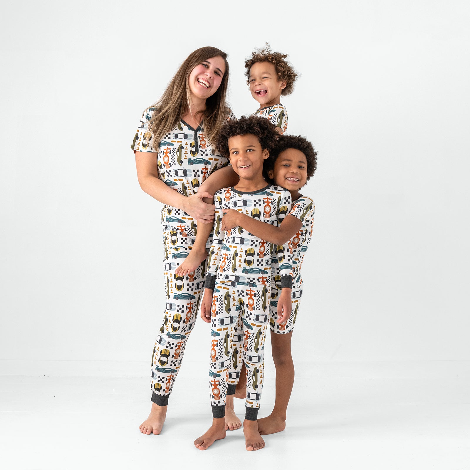 Family of four wearing matching Fast Lane bamboo pajamas
