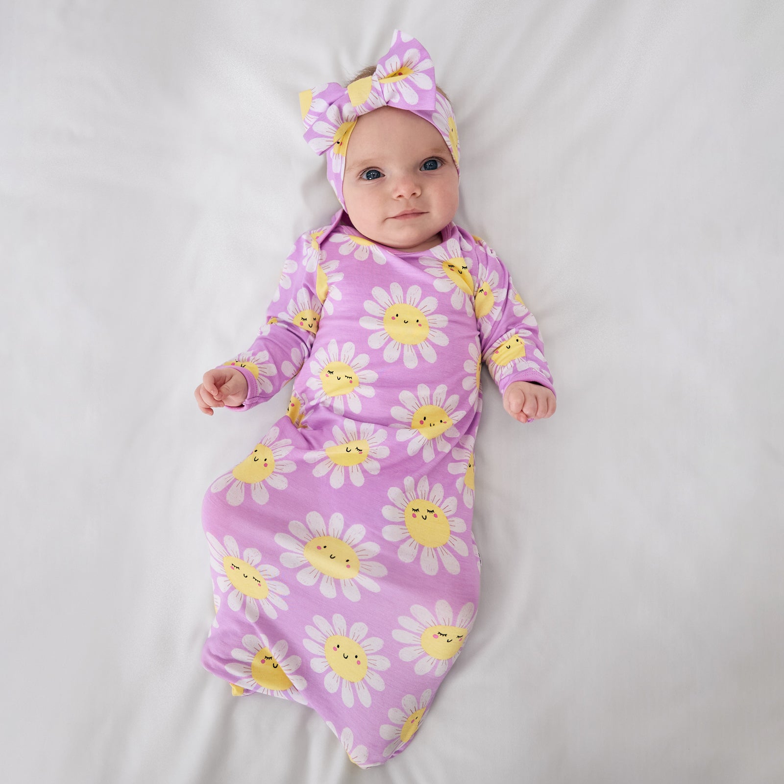 Aerial view of child wearing the Flower Power Infant Gown with the matching luxe bow headband