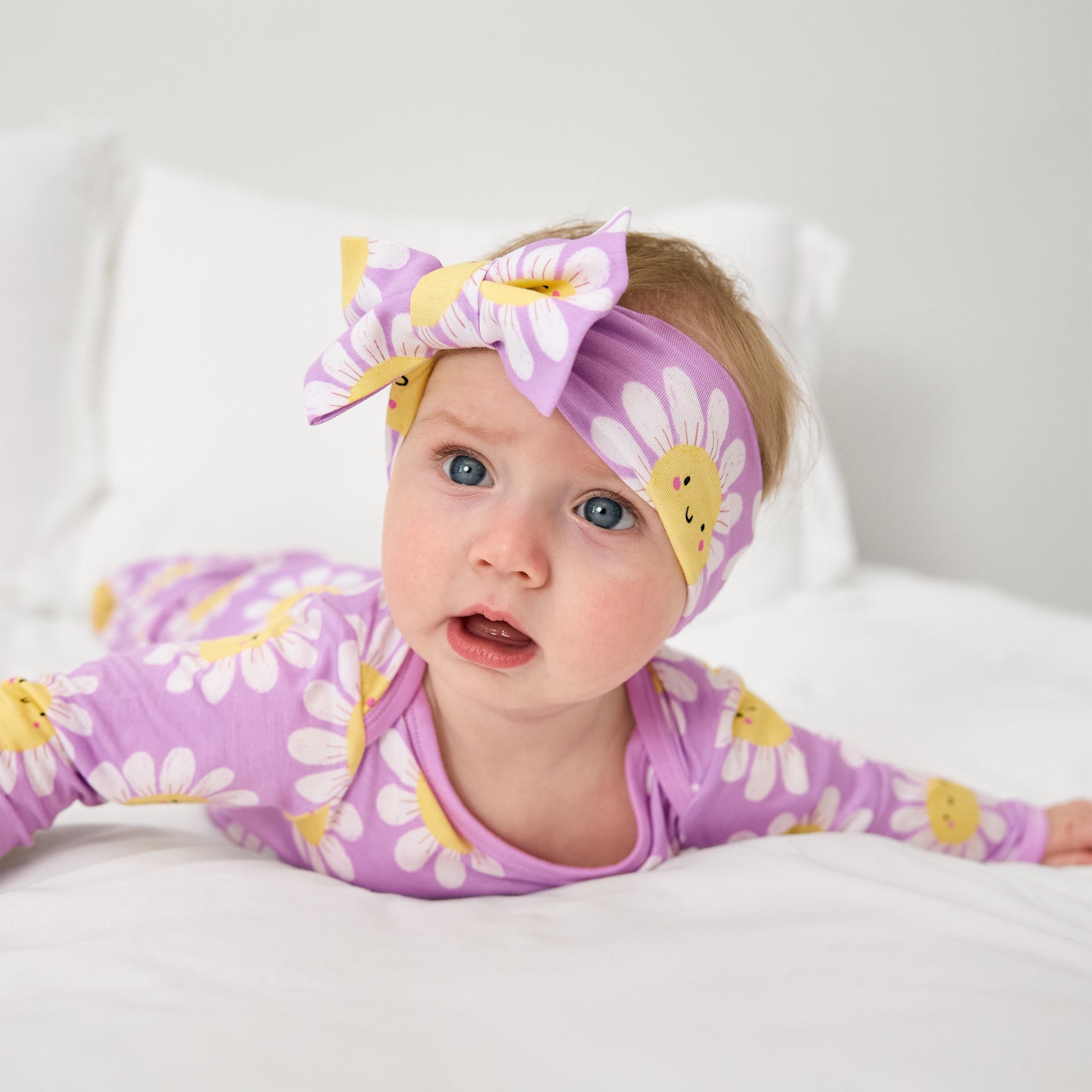 Baby on her tummy wearing the Flower Power Luxe Bow Headband