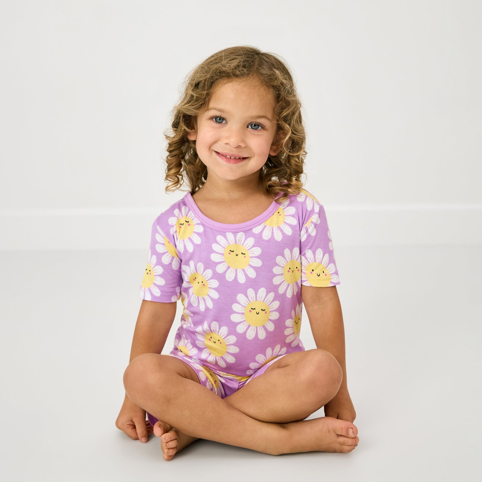 Sitting child wearing the Flower Power Two-Piece Short Sleeve & Shorts Pajama Set