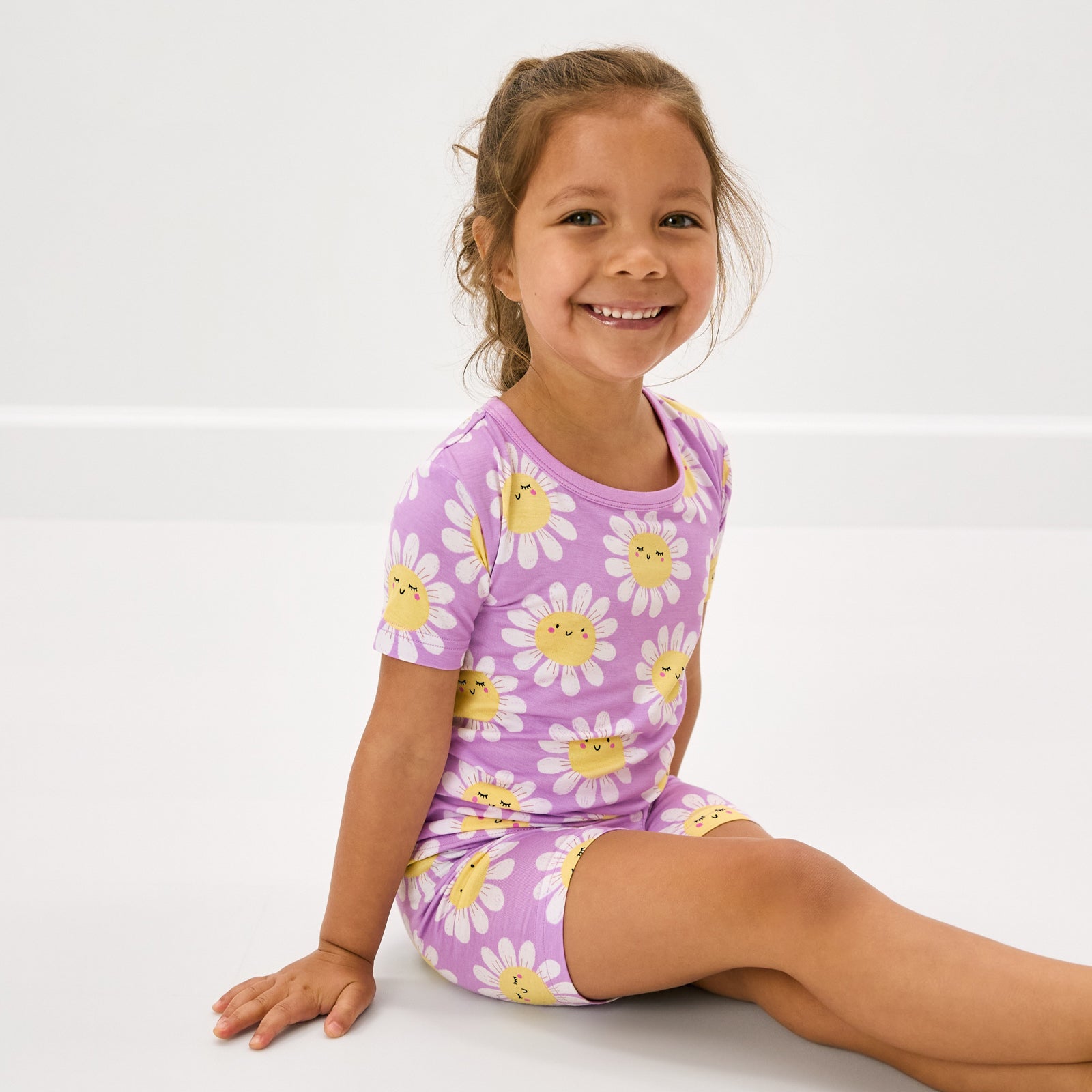 Sitting child wearing the Flower Power Two-Piece Short Sleeve & Shorts Pajama Set