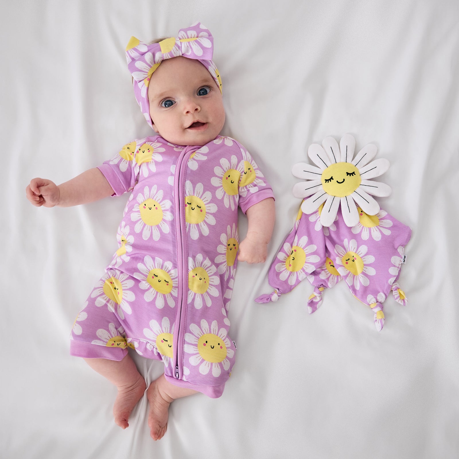 Aerial view of child laying with the Maisie the Daisy Sleepyhead Lovey