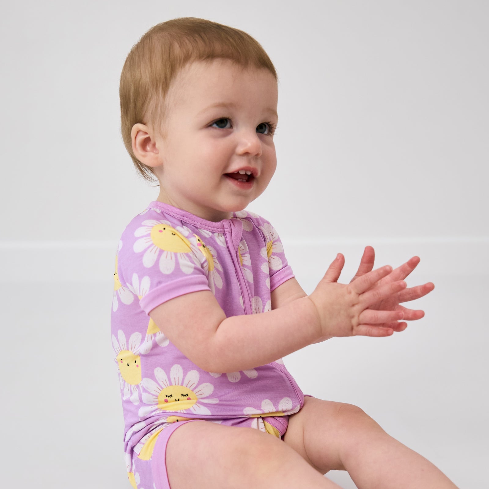 Sitting child wearing the Flower Power Shorty Zippy