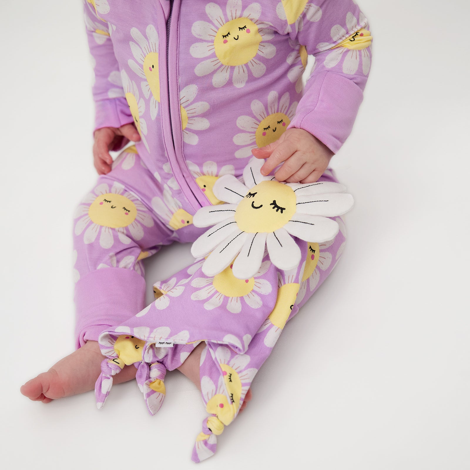 Sitting baby holding the Maisie the Daisy Sleepyhead Lovey
