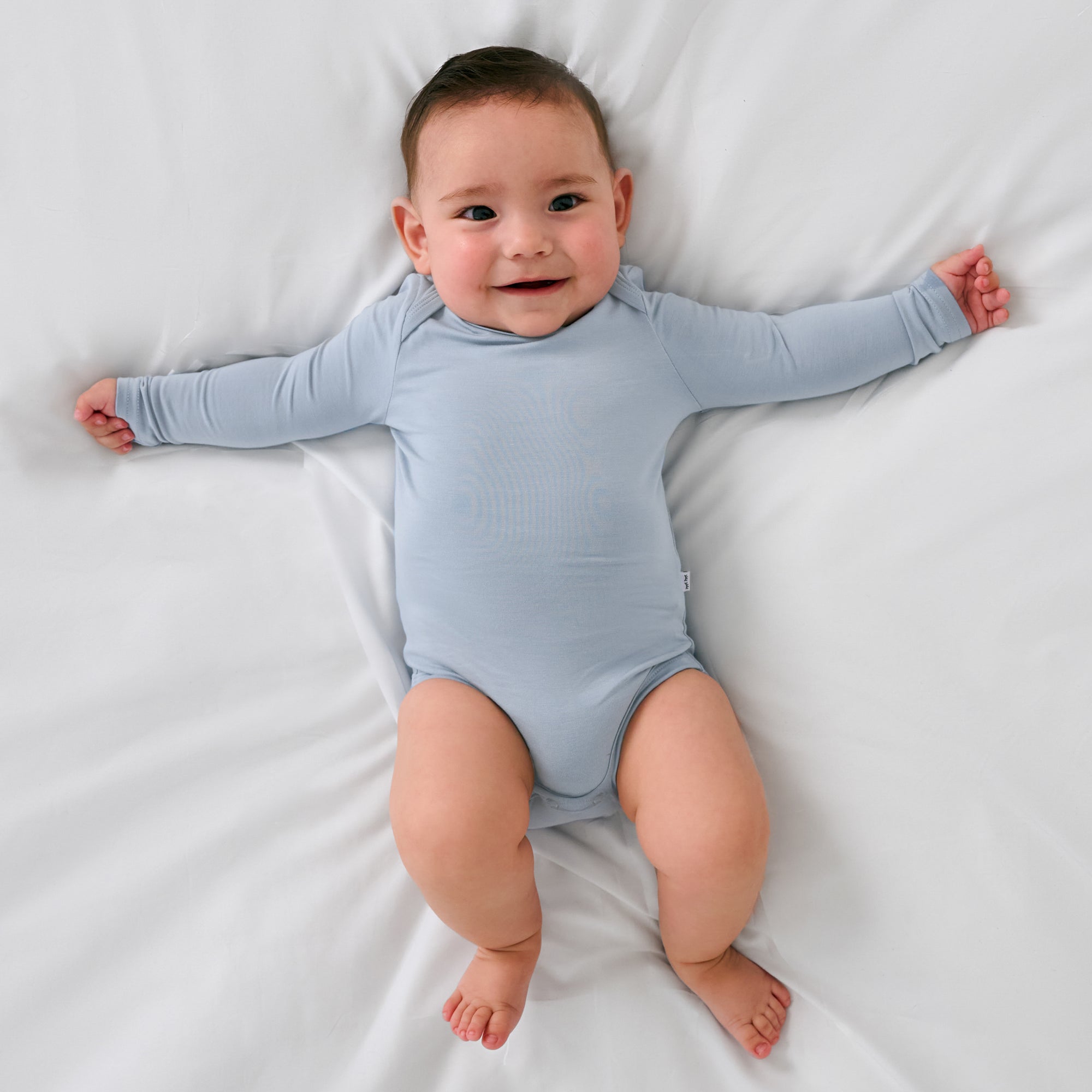 Aerial view of child wearing the Fog Long Sleeve Bodysuit