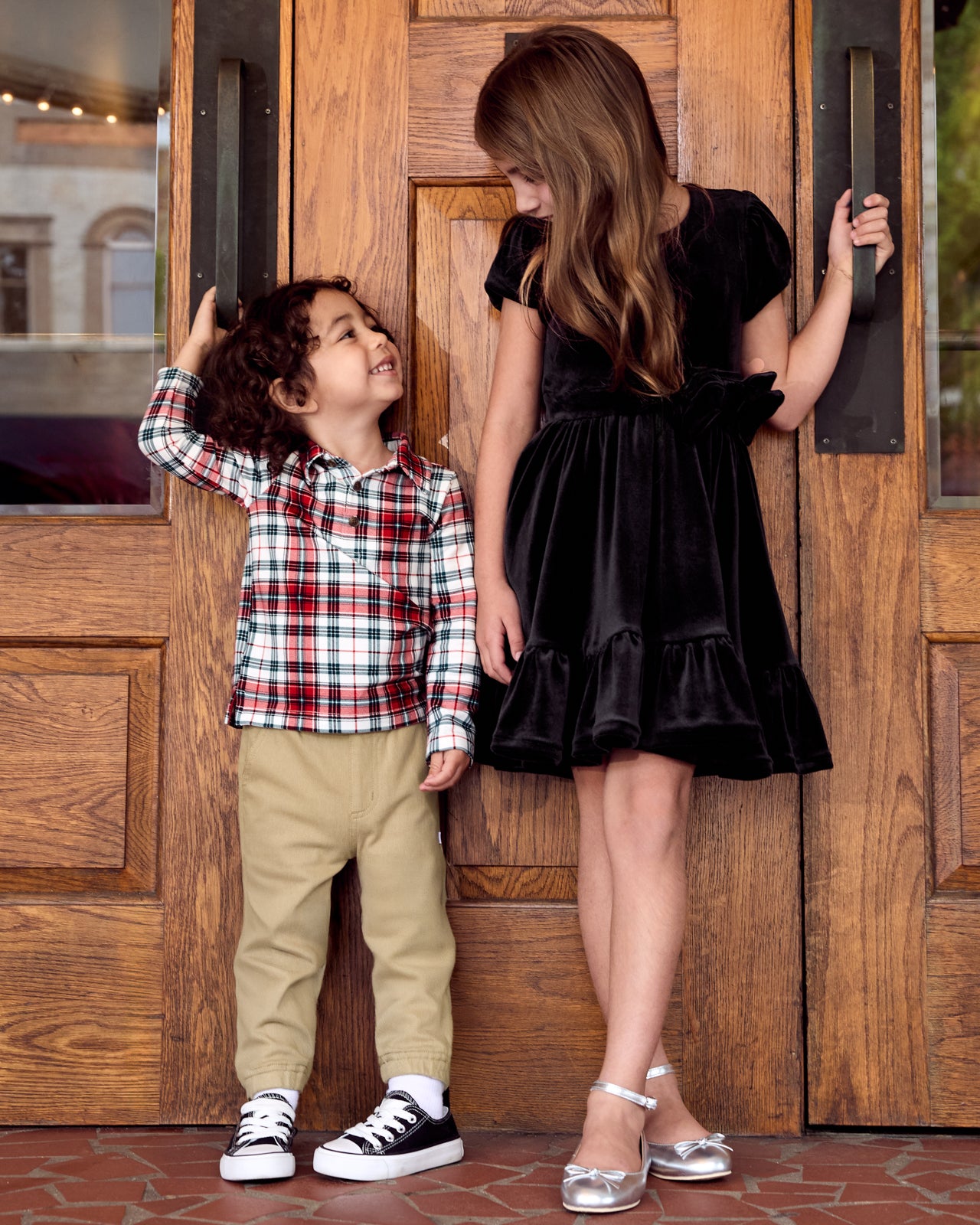 Two children wearing play styles from the Holiday Collection