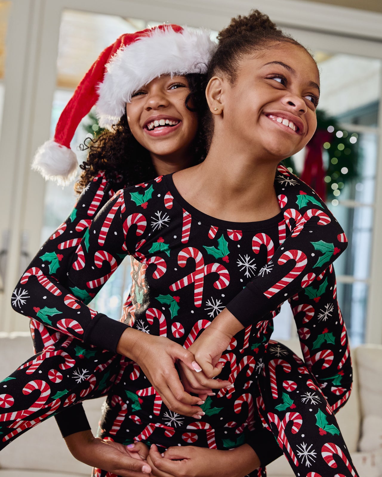 Two girls wearing Merry Mints Two-Piece Pajama Sets
