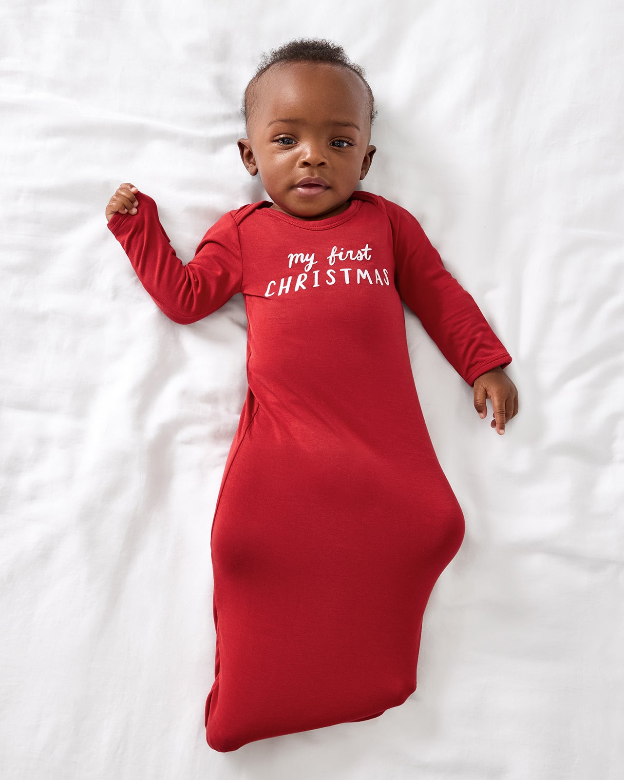 Aerial view of baby wearing the My First Christmas Infant Gown