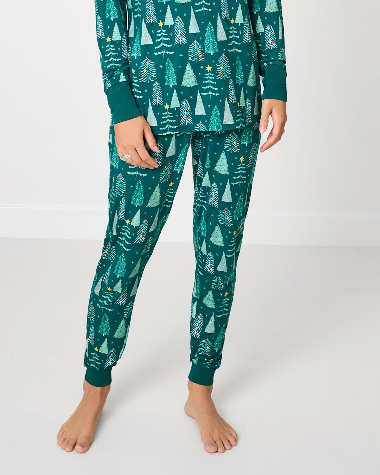Woman wearing the Twinkling Trees Holiday themed Women's Pajama Pants