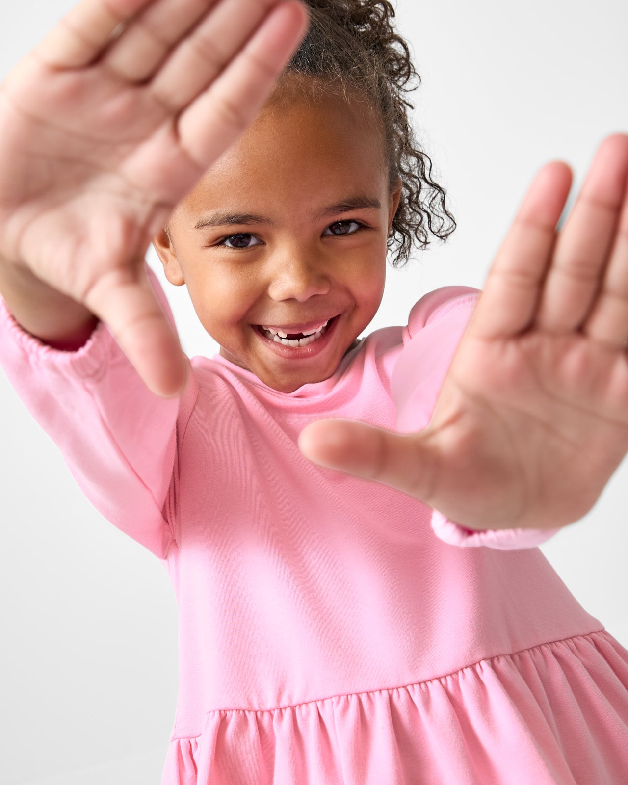 Posing girl wearing the Gumball Pink Puff Sleeve Peplum Top