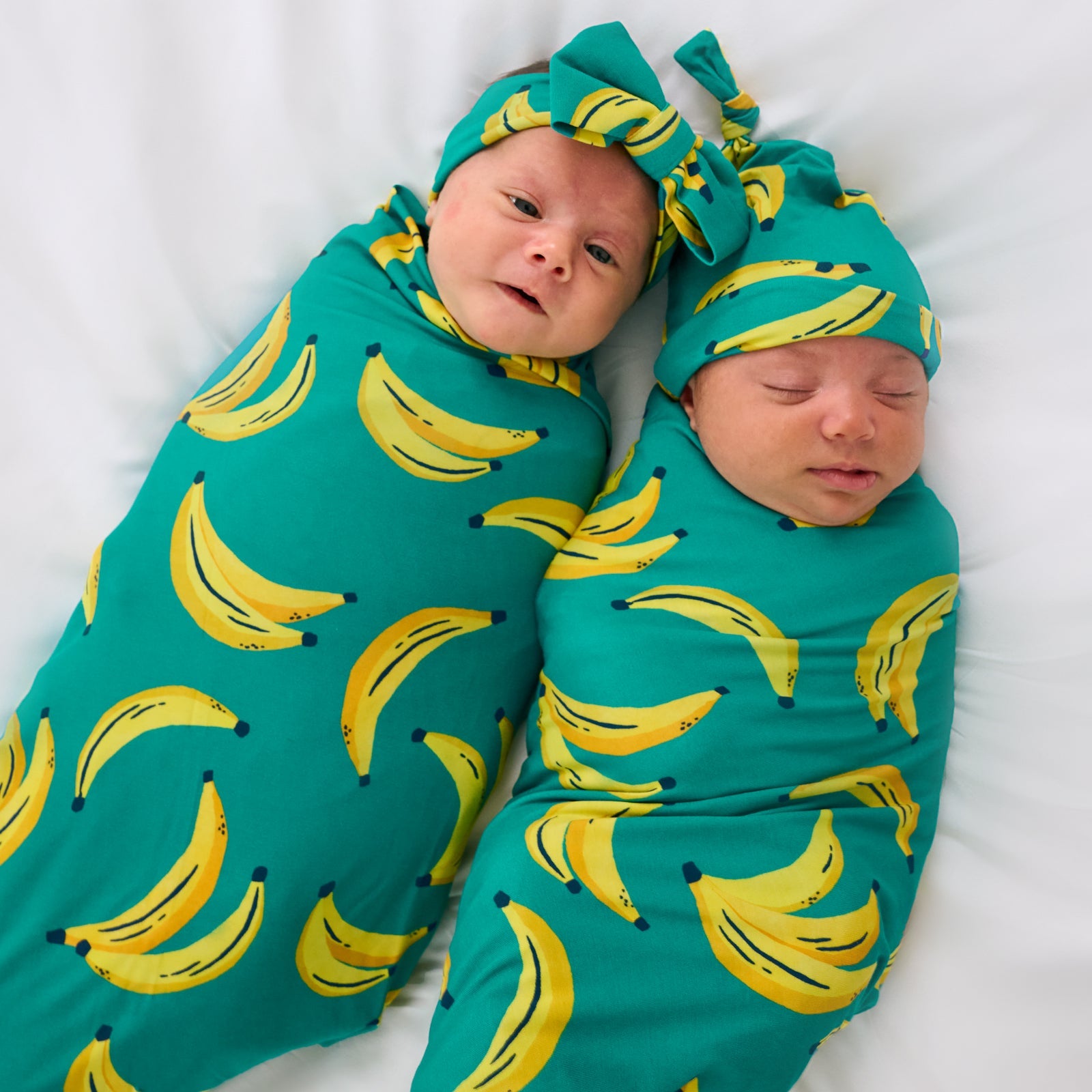 Aerial view of two children wearing matching Go Bananas Swaddle Sets