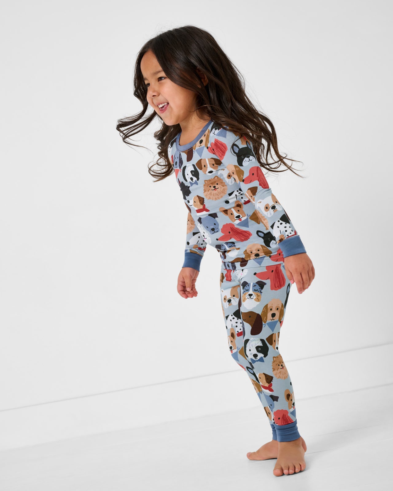 Standing girl wearing the Gray Puppy Parade Two-Piece Pajama Set