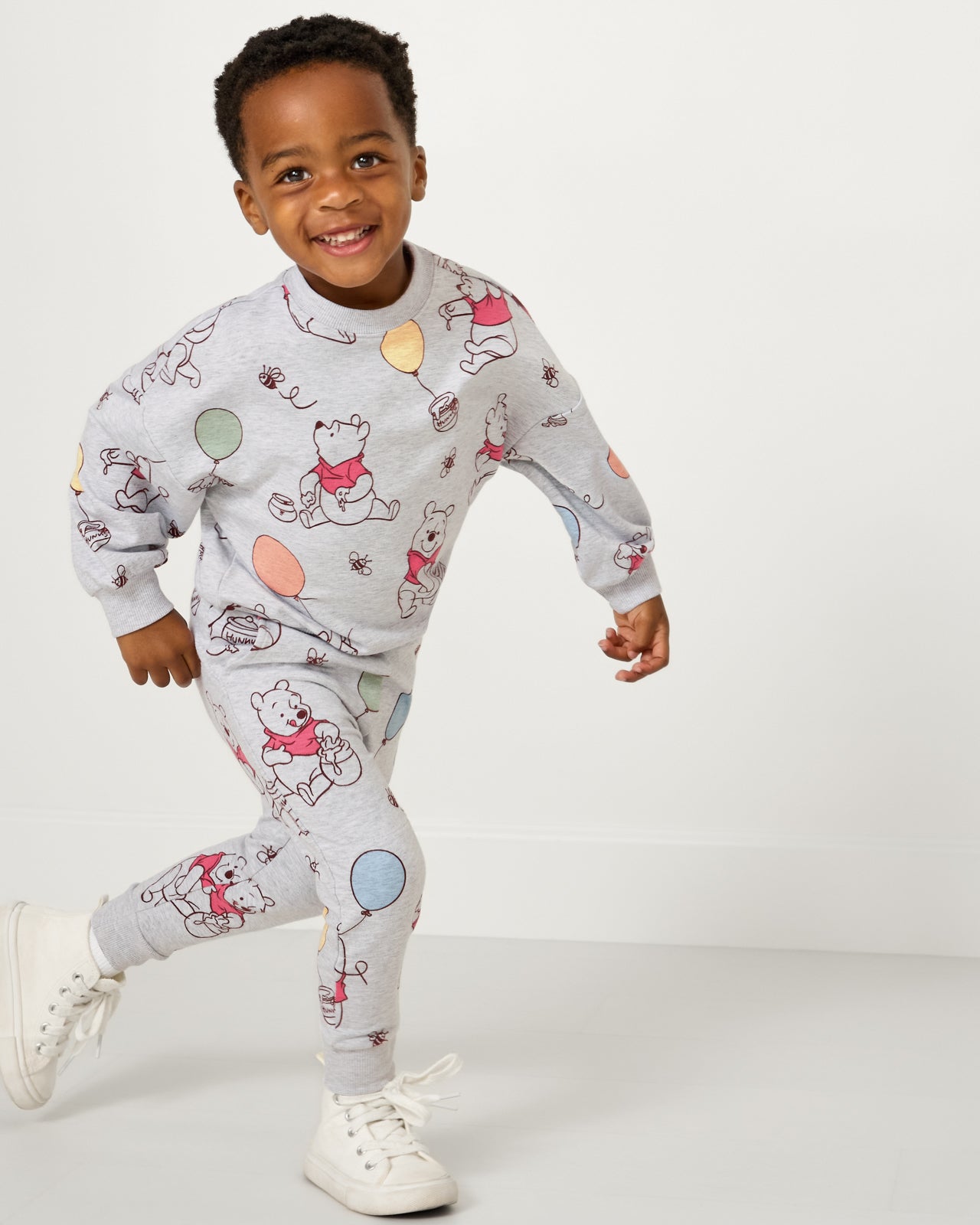 Running boy wearing the Disney Up, Up and Away Jogger and Crewneck