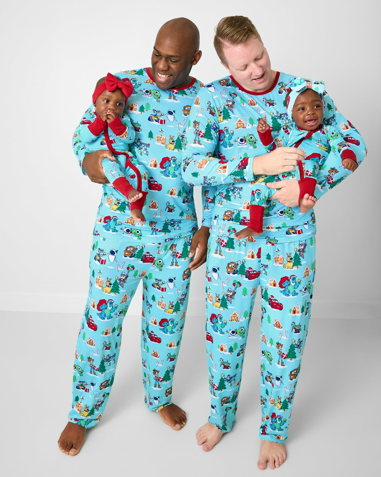 Family of four wearing matching Disney & Pixar Christmas Village bamboo christmas pajamas