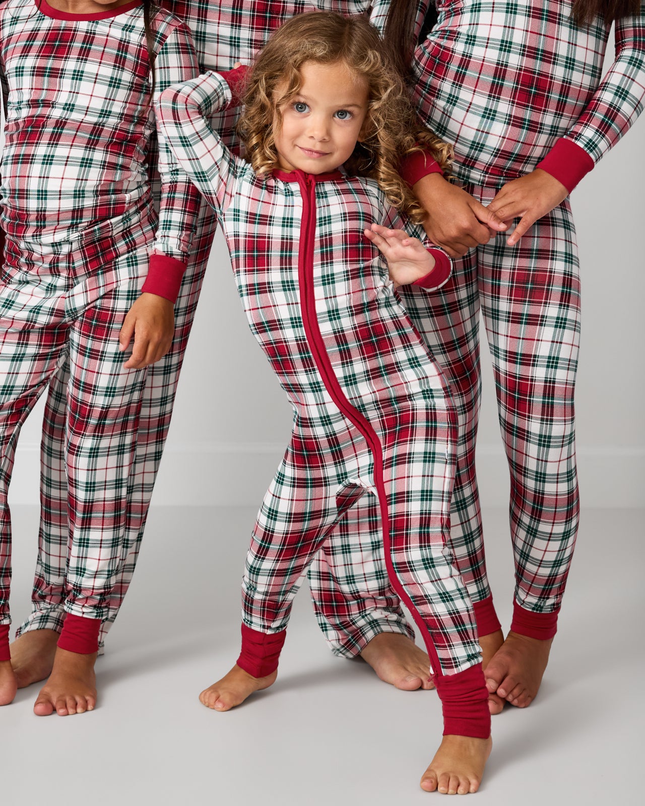 Posing toddler wearing the Holly Plaid Zippy