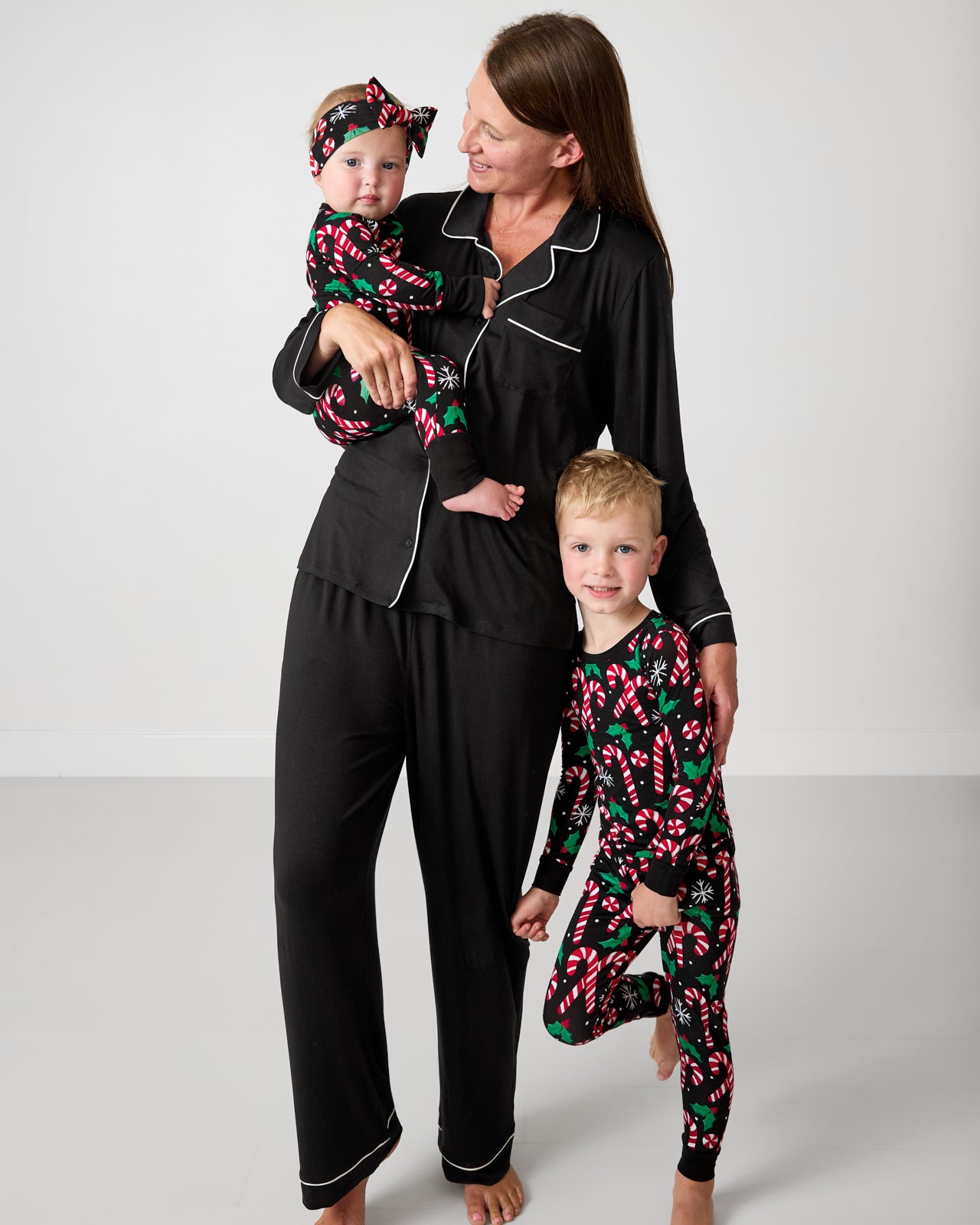 Mother and two children wearing pajamas from the Little Sleepies Holiday Collection