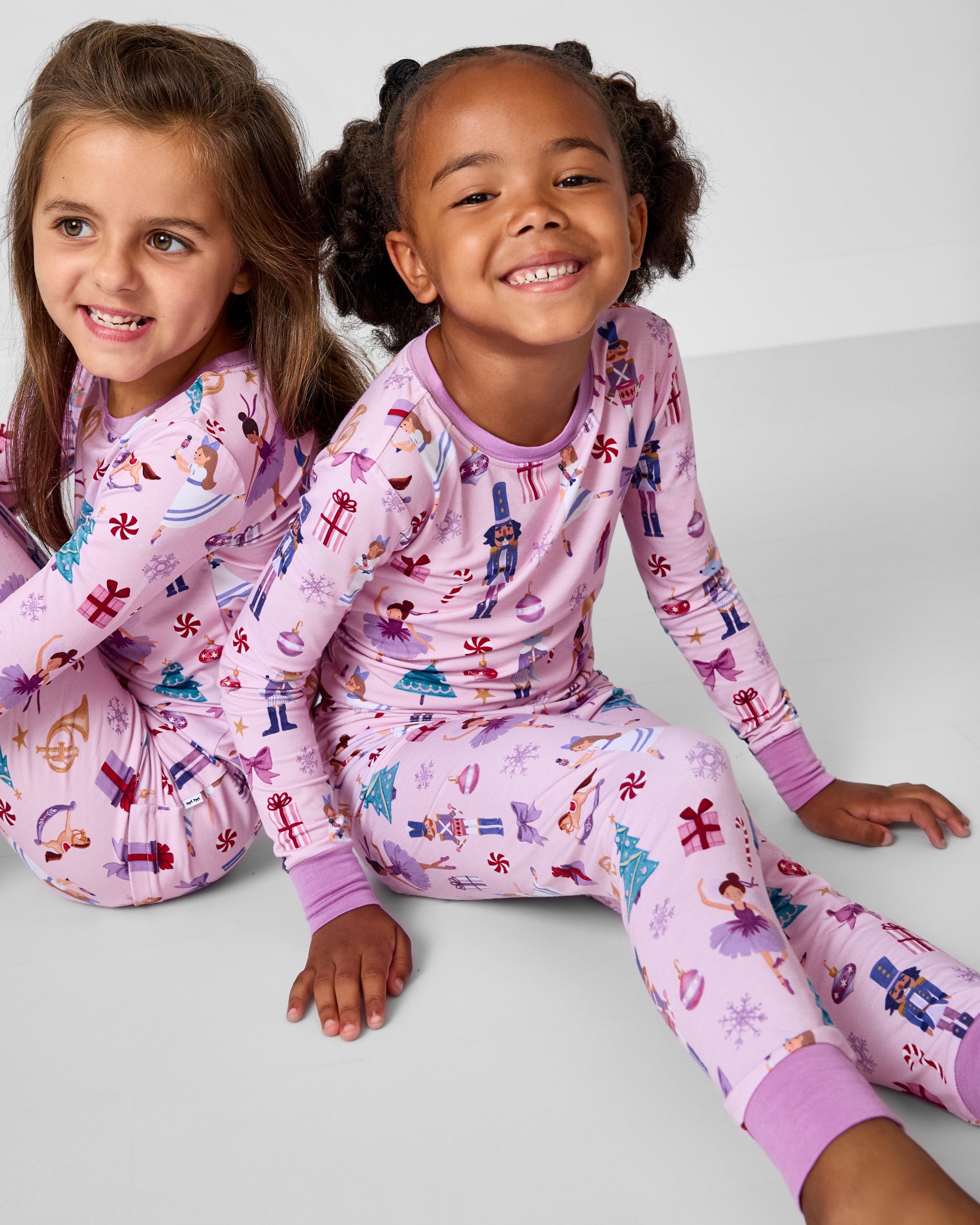 Two girls wearing matching Nutcracker Ballet Two-Piece Pajama Sets