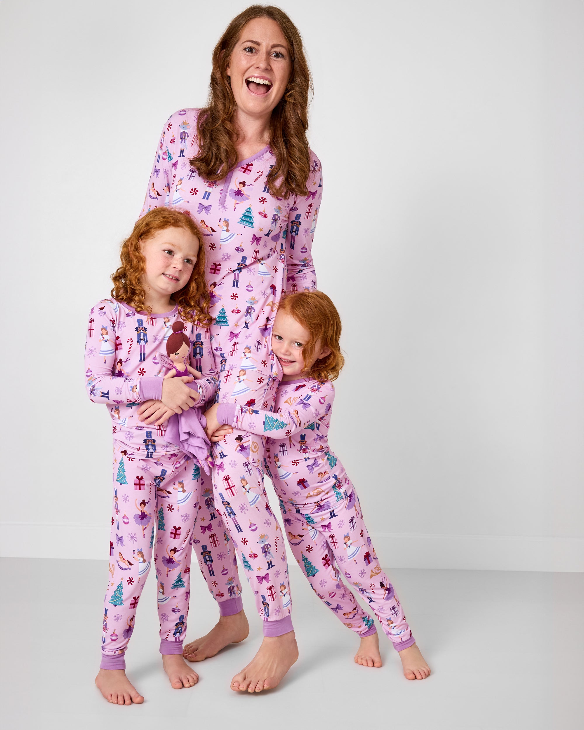 Mother and two children wearing matching Nutcracker Ballet pajamas