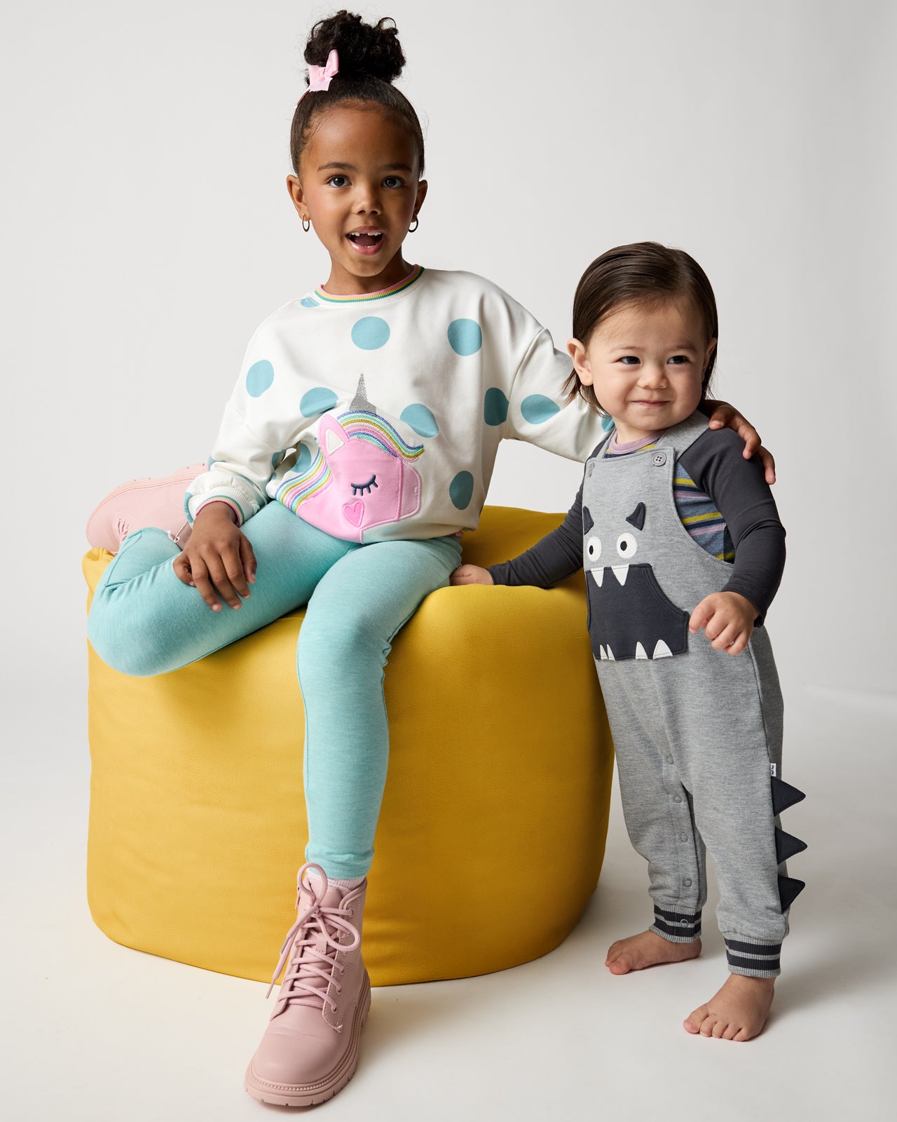 Two children wearing graphic styles from the Winter Play collection