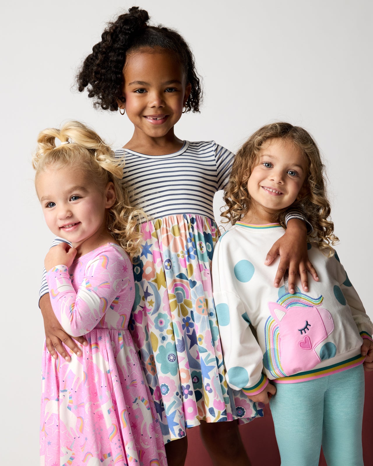 Three girls wearing Unicorn styles from the Winter Play drop