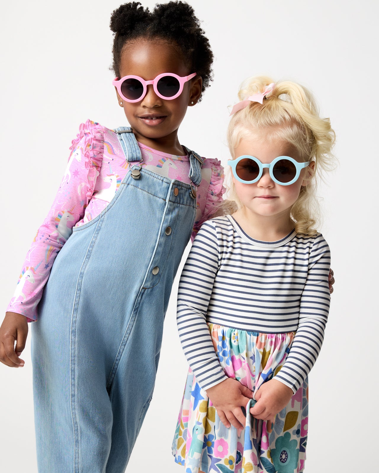 Two girls wearing round sunglasses and styles from the Winter Play collection