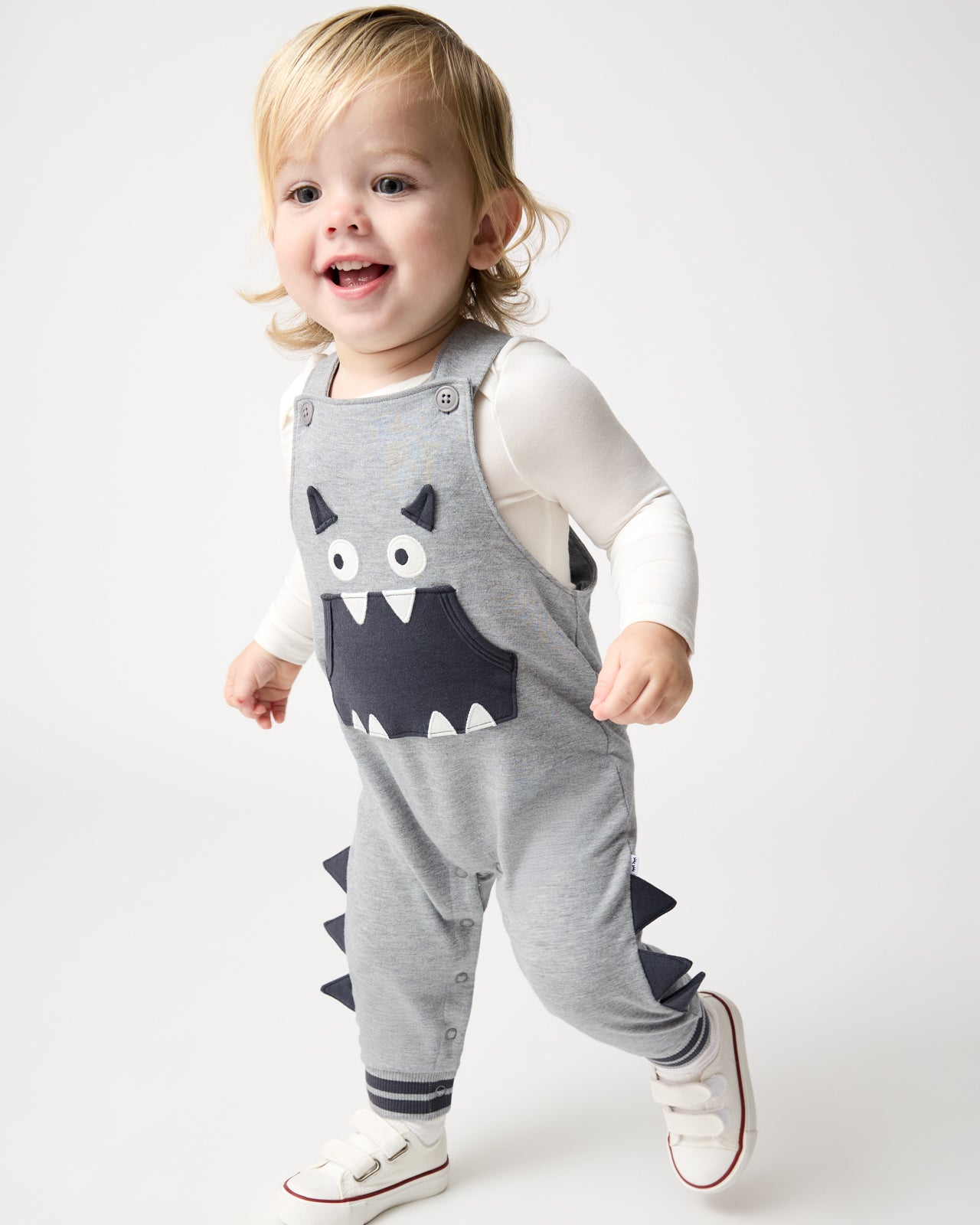 Walking toddler wearing the Monster Overall